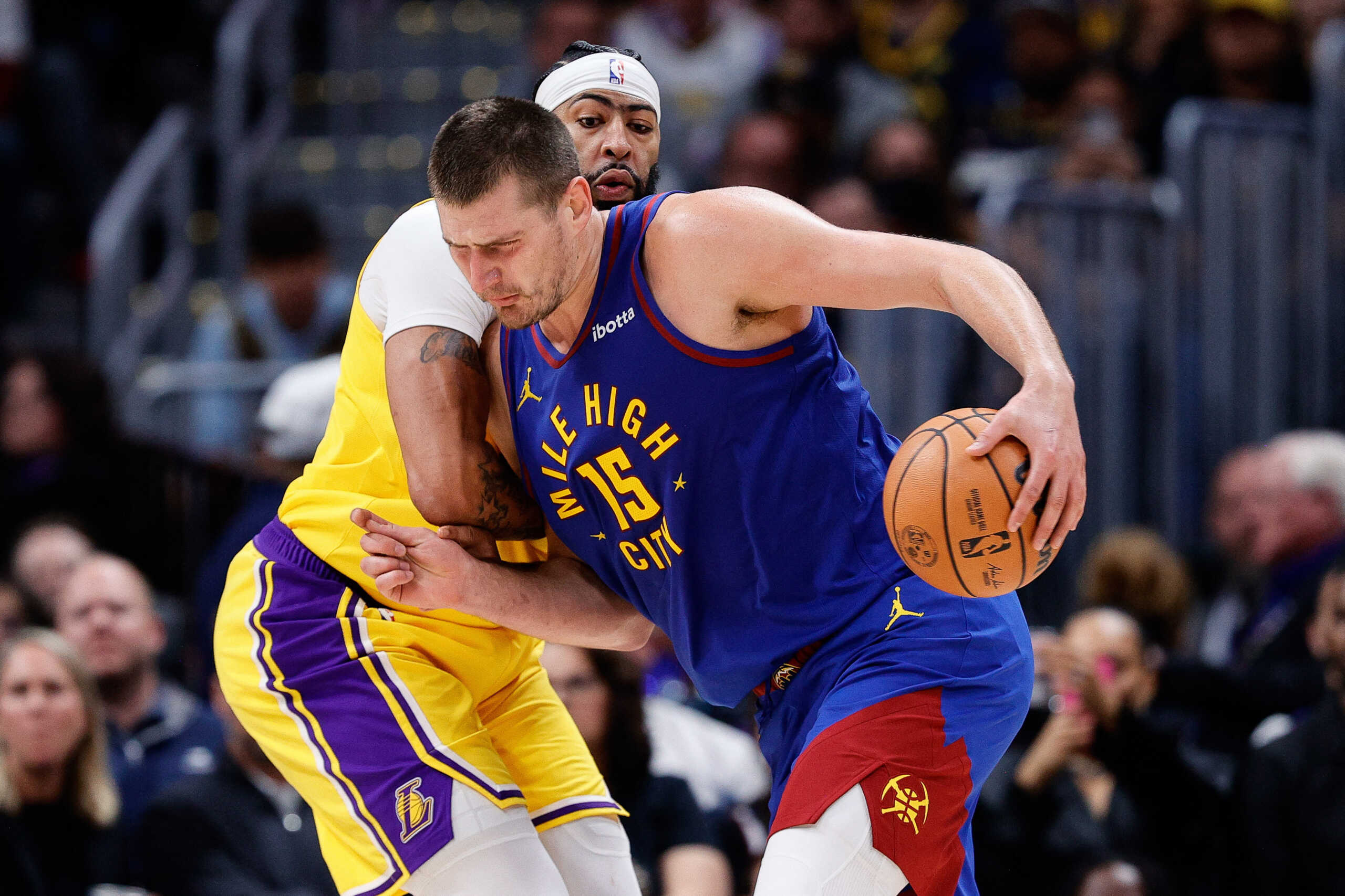Oct 24, 2023; Denver, Colorado, USA; Denver Nuggets center Nikola Jokic (15) controls the ball as Los Angeles Lakers forward Anthony Davis (3) guards in the third quarter at Ball Arena. Mandatory Credit: Isaiah J. Downing-USA TODAY Sports