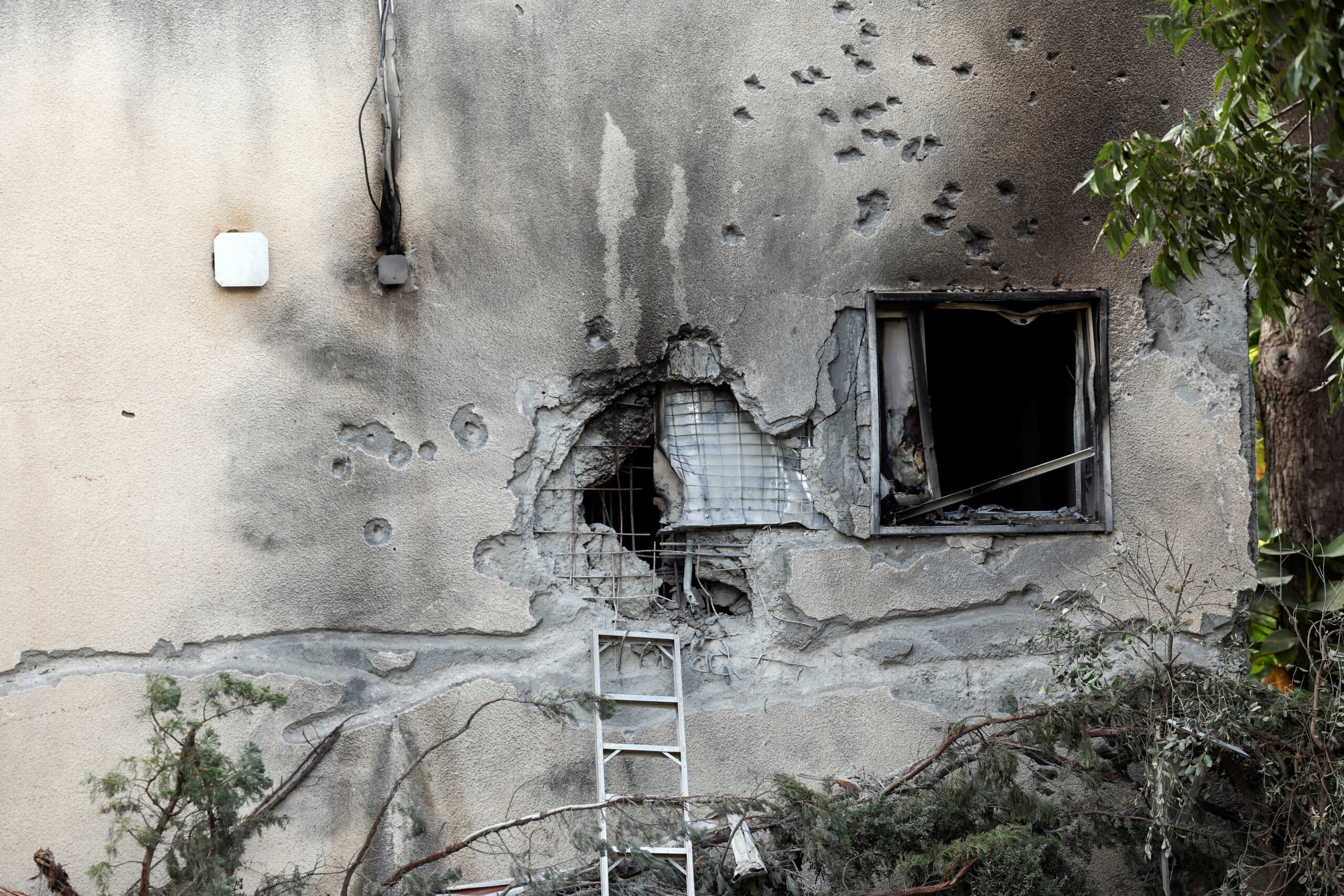 Bullet holes are seen on the wall of a burnt house, following a deadly infiltration by Hamas gunmen from the Gaza Strip, in Kibbutz Kfar Aza in southern Israel, October 15, 2023. REUTERS