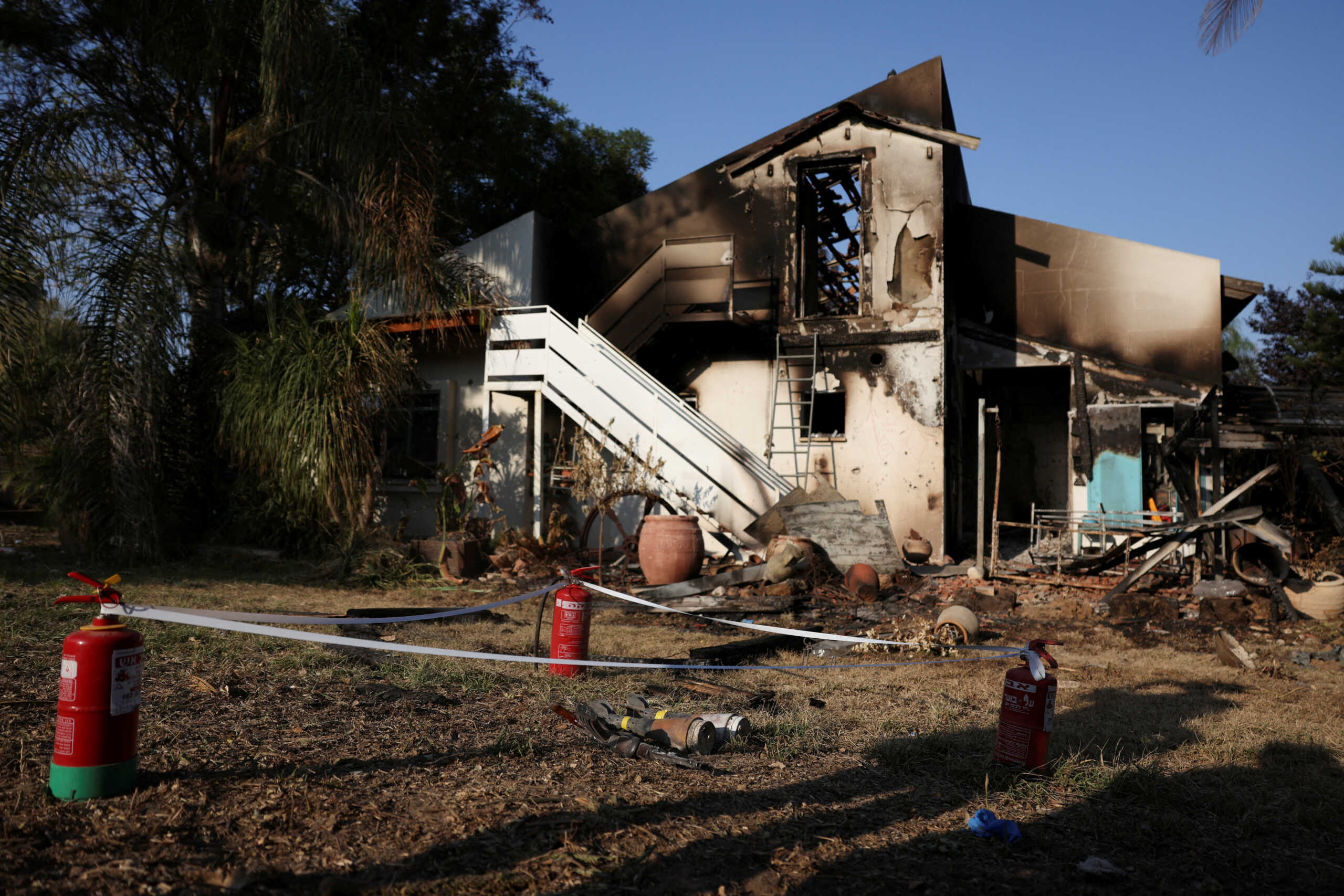 A rifle and parts of rockets lie in front of a damaged house, in the aftermath of a mass infiltration by Hamas gunmen from the Gaza Strip, in Kibbutz Beeri in southern Israel, October 14, 2023. REUTERS