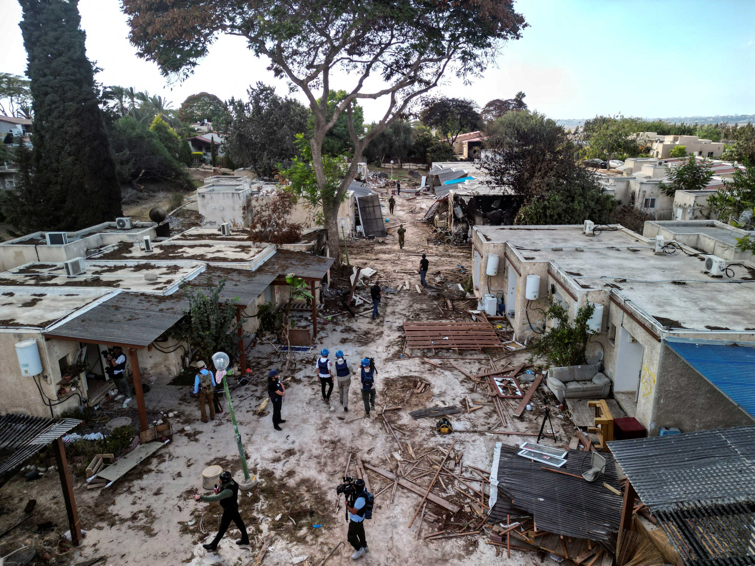 An aerial view shows members of the media during a visit to Kibbutz Kfar Aza, in the aftermath of a deadly attack by Hamas gunmen from the Gaza Strip, in southern Israel, October 15, 2023. REUTERS