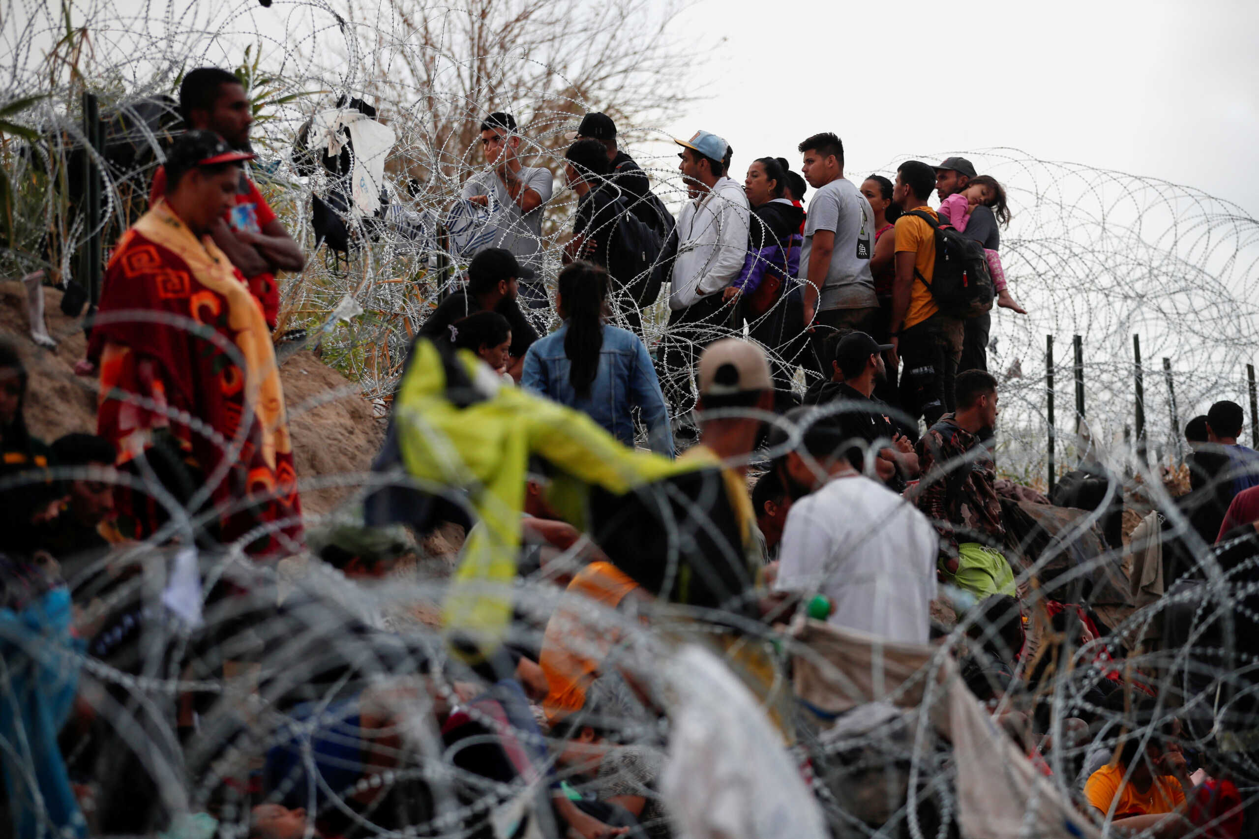 Migrants wait on the banks of the Rio Grande river in an attempt to seek asylum into the U. S., as seen from Piedras Negras, Mexico September 30, 2023. REUTERS