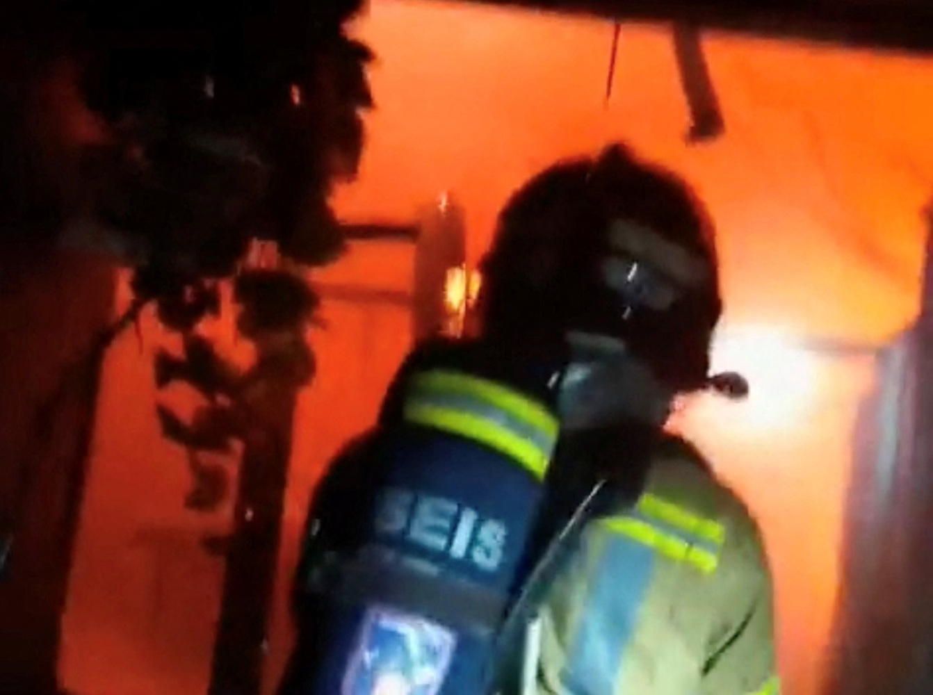 Firefighters work to control flames inside a nightclub in Murcia, Spain, October 1, 2023, in this screen grab obtained from a handout video. Murcia Firefighters