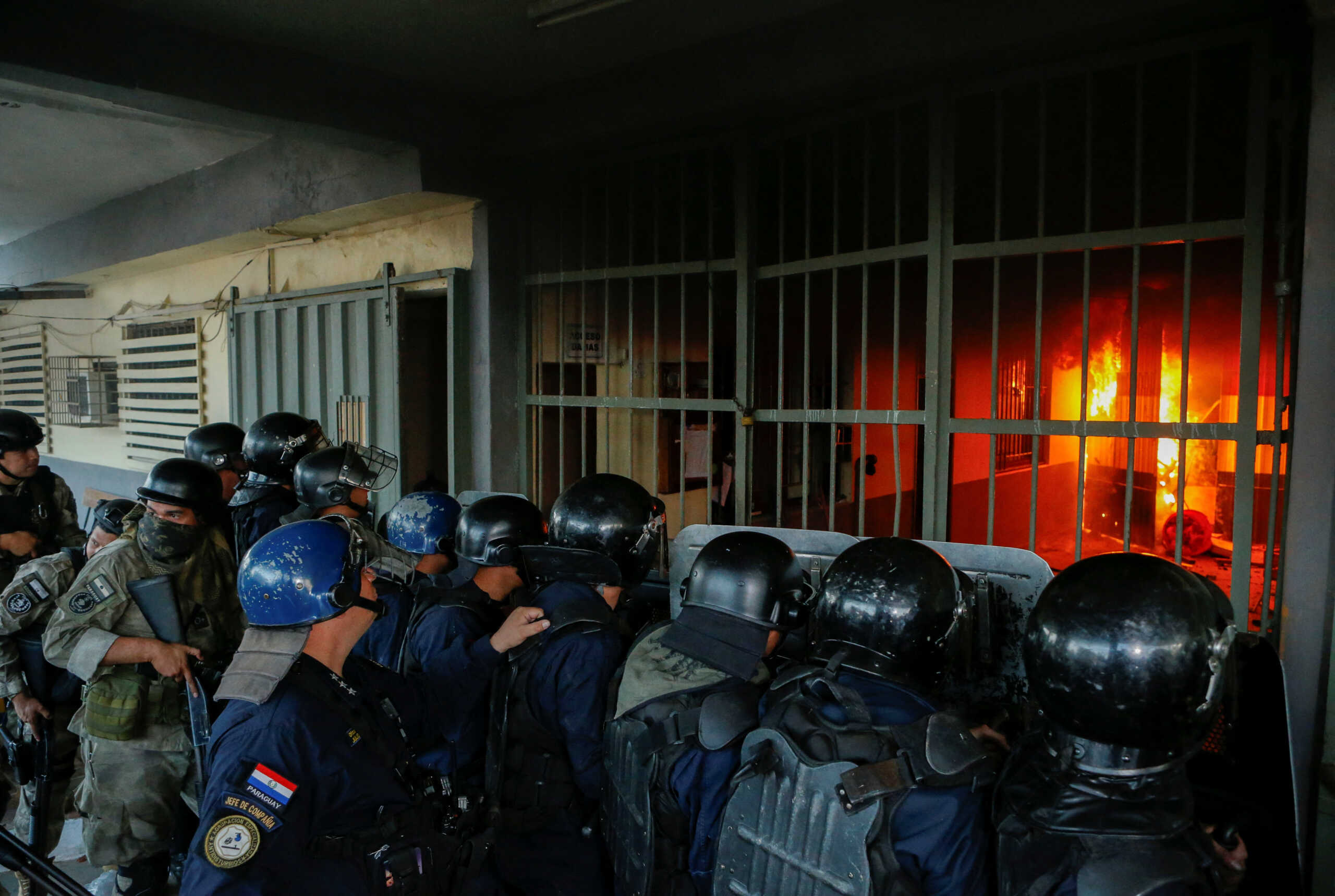 Police stand outside the Tacumbu penitentiary during a riot after inmates took hostage a dozen officials and caused a fire, in Asuncion, Paraguay October 10, 2023. REUTERS