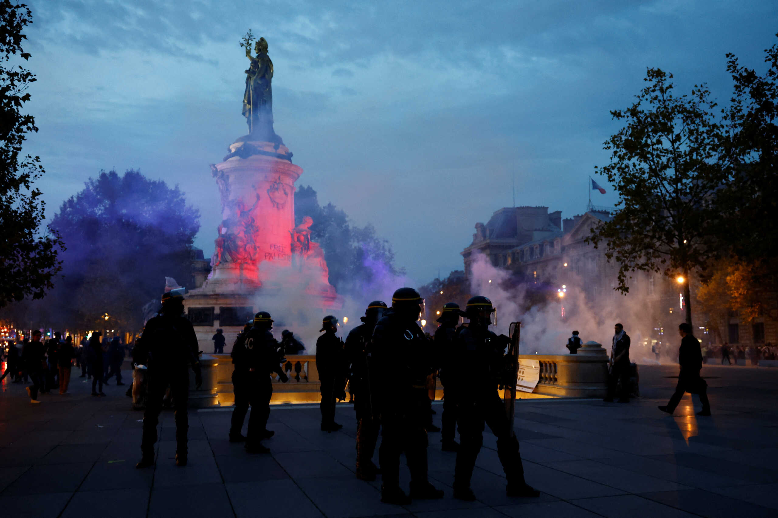 French CRS riot police stand on position at Place de la Republique during clashes with protestors during an unauthorized demonstration in support of Palestinians, as part of the ongoing conflict between Israel and the Palestinian Islamist group Hamas, in Paris as French Interior Minister Gerald Darmanin ordered the systematic banning of pro-Palestinian demonstrations and the arrest of participants within France, October 12, 2023. REUTERS