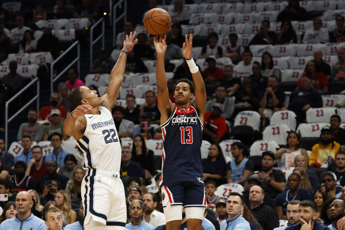 Oct 28, 2023; Washington, District of Columbia, USA; Washington Wizards guard Jordan Poole (13) shoots the ball over Memphis Grizzlies guard Desmond Bane (22) in the first quarter at Capital One Arena. Mandatory Credit: Geoff Burke-USA TODAY Sports