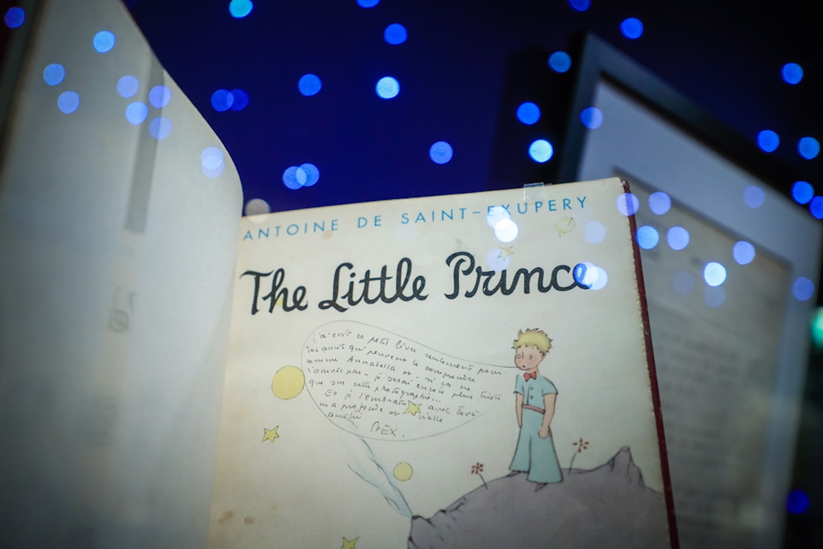 epa09762475 An original English edition of 'The Little Prince' with a dedication by the author on display during the presentation of the exhibition 'A la Rencontre du Petit Prince' (Meet the Little Prince) at the 'Musee des Art Decoratifs de Paris', in Paris, France, 16 February 2022. The exhibition features some 600 artworks by the French writer and designer Antoine de Saint Exupery, including for the first time exhibited in France, the original manuscript dating from 1943 which has since remained in New York. The exhibition runs from 17 February to 26 June 2022.  EPA