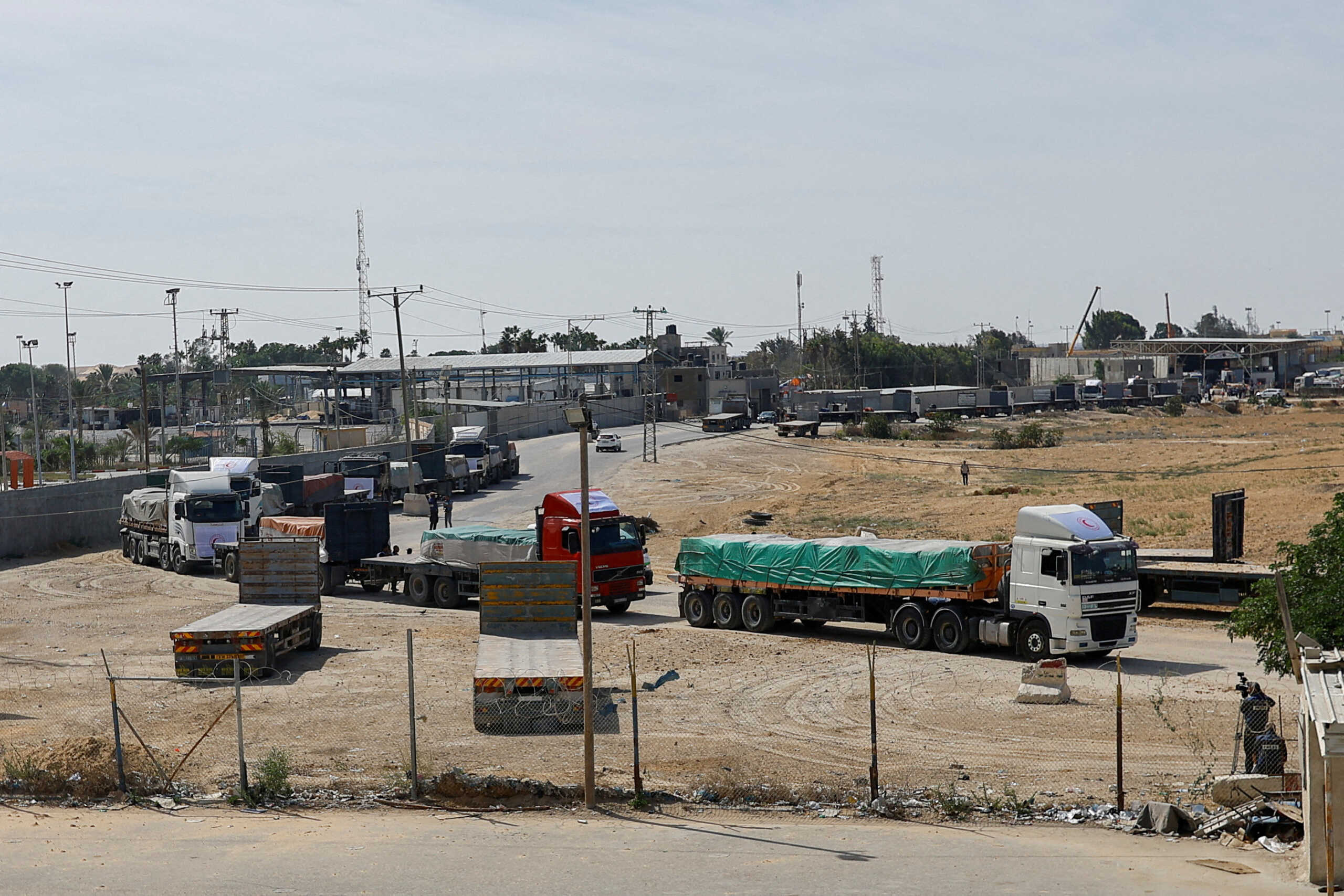 FILE PHOTO: Trucks carrying aid wait to exit, on the Palestinian side of the border with Egypt, as the conflict between Israel and Palestinian Islamist group Hamas continues, in Rafah in the southern Gaza Strip, October 21, 2023. REUTERS