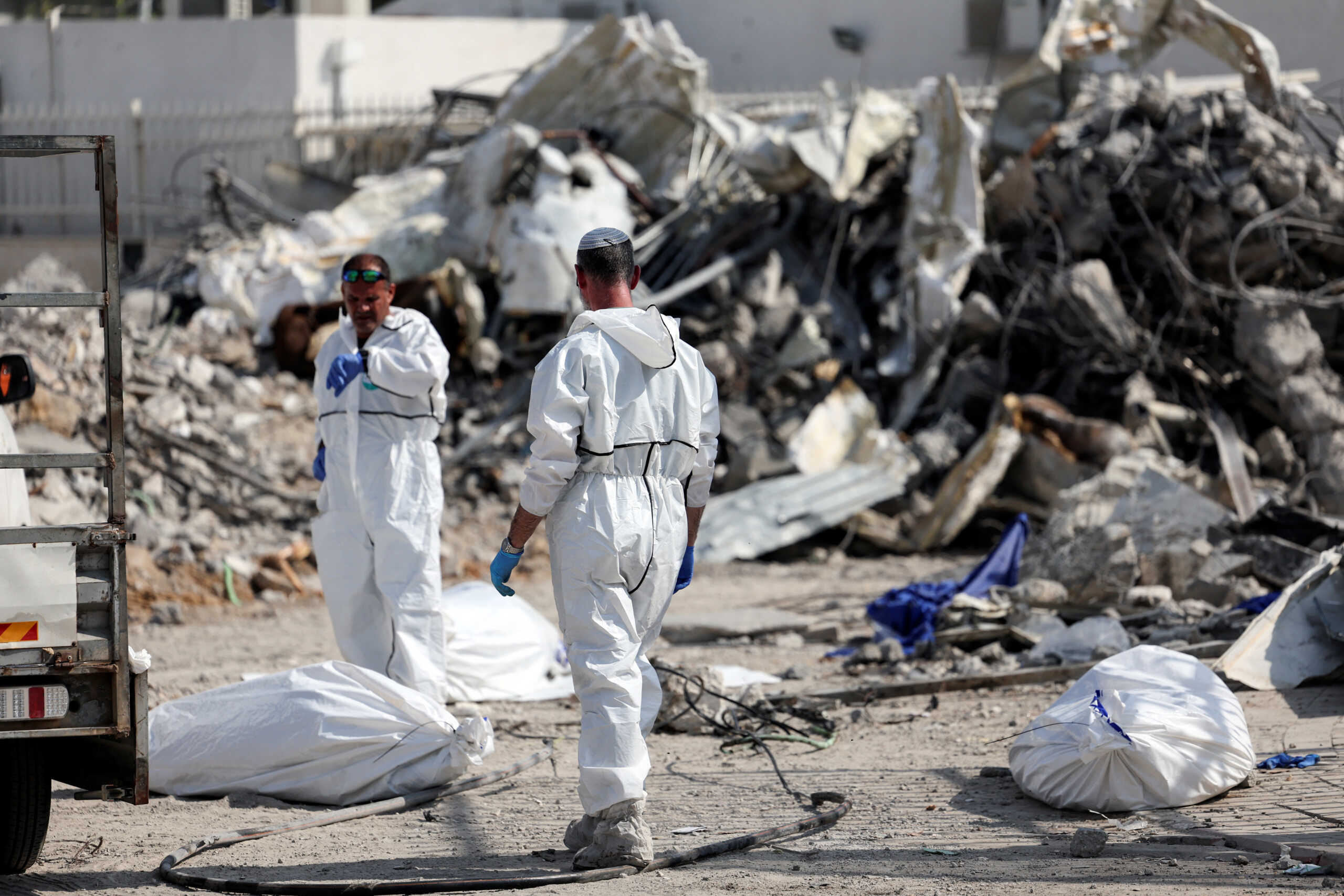 Israeli rescue workers work to remove dead bodies from near a destroyed police station that was the site of a battle following a mass-infiltration by Hamas gunmen from the Gaza Strip, in Sderot, southern Israel, October 11, 2023. REUTERS