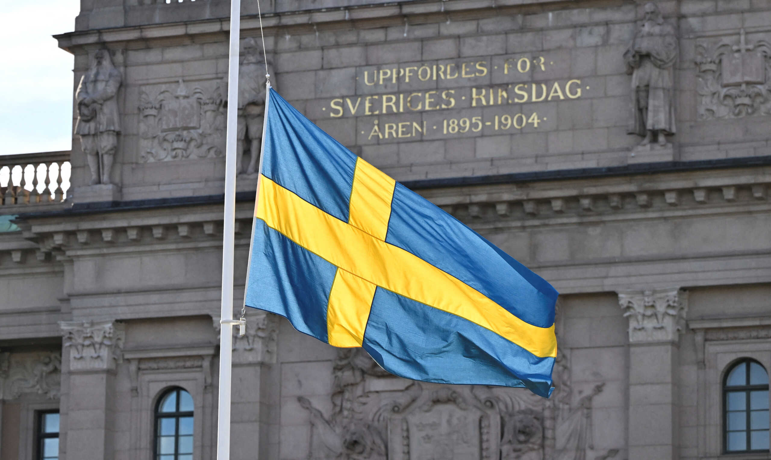 The victims of the attack in Brussels are honored when the Swedish Parliament flags are flown at half-mast while the memorial service takes place, in Stockholm, Sweden October 17, 2023. TT News Agency