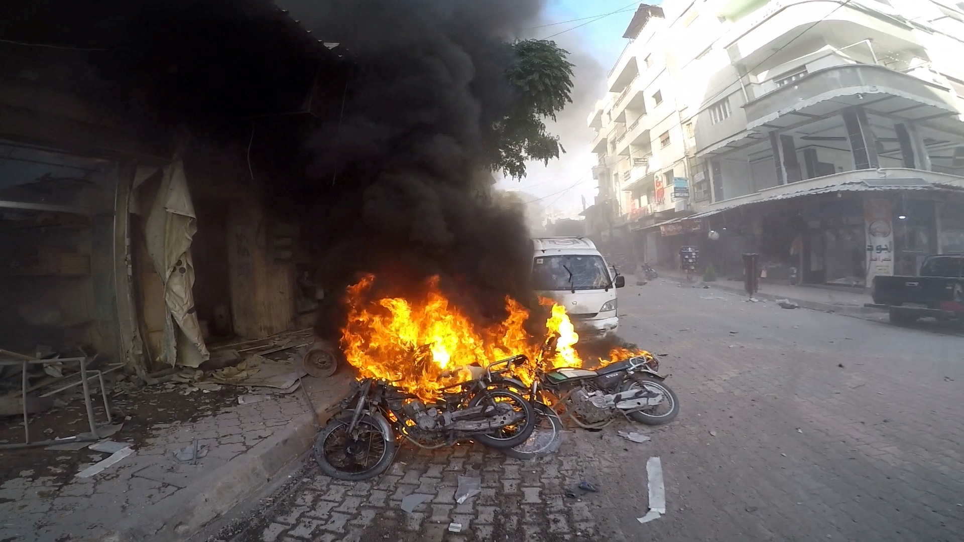 Smoke rises from vehicles set on fire, in the aftermath of strikes held by the Syrian army according to the White Helmets, in Jisr ash-Shughur, Idlib, Syria, October 5, 2023. White Helmets