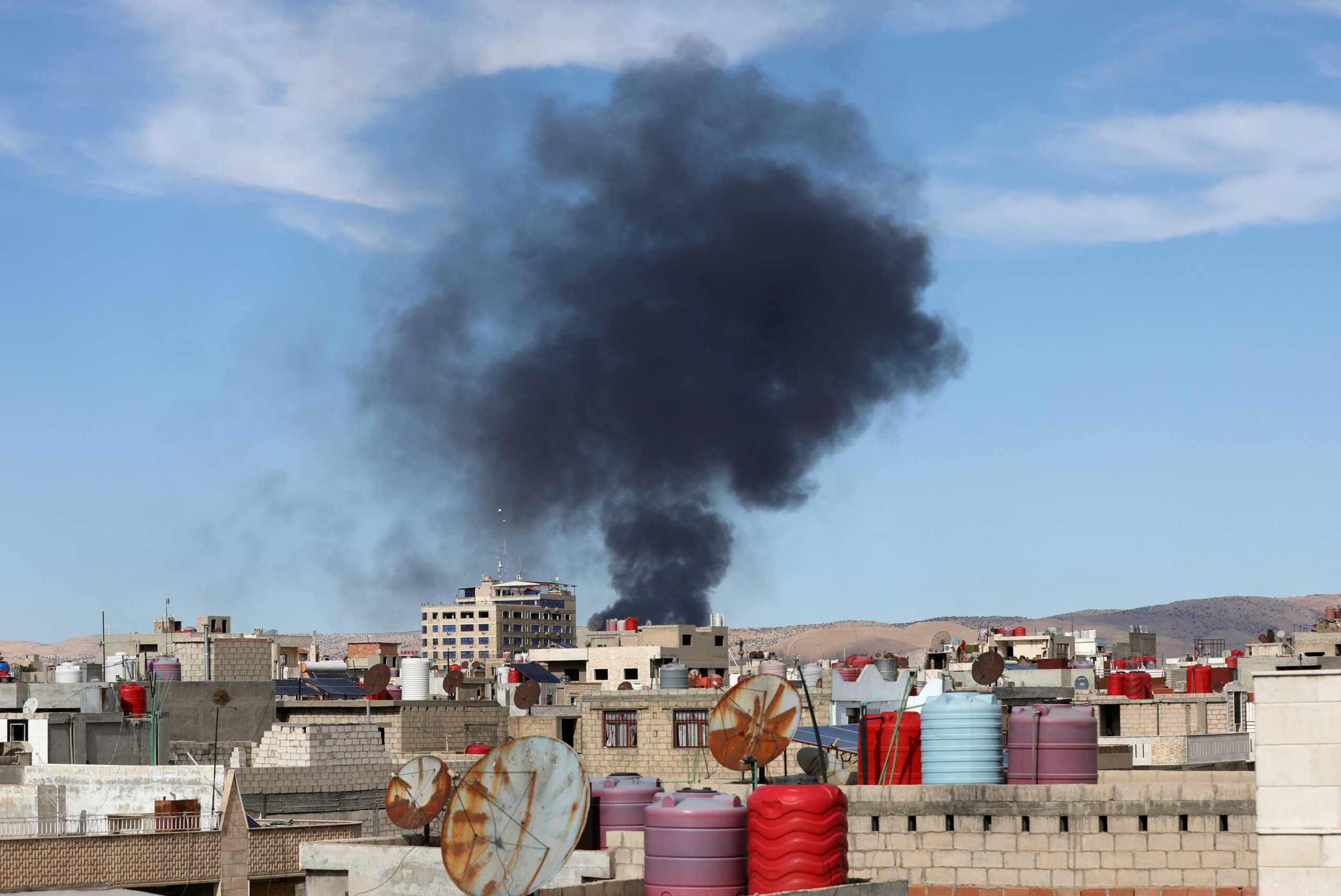 Smoke rises from Syria's Kurdish-controlled northeast city of Qamishli, Syria October 5, 2023. REUTERS