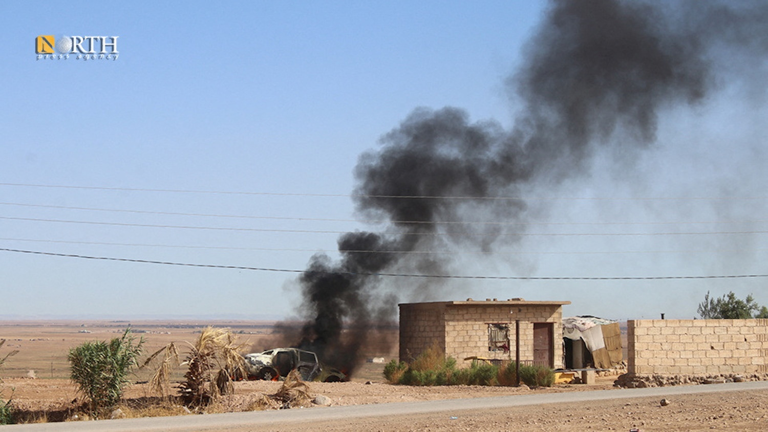 Smoke rises from a car after an alleged Turkish strike on Hasakah, Syria, October 5, 2023. North Press Agency