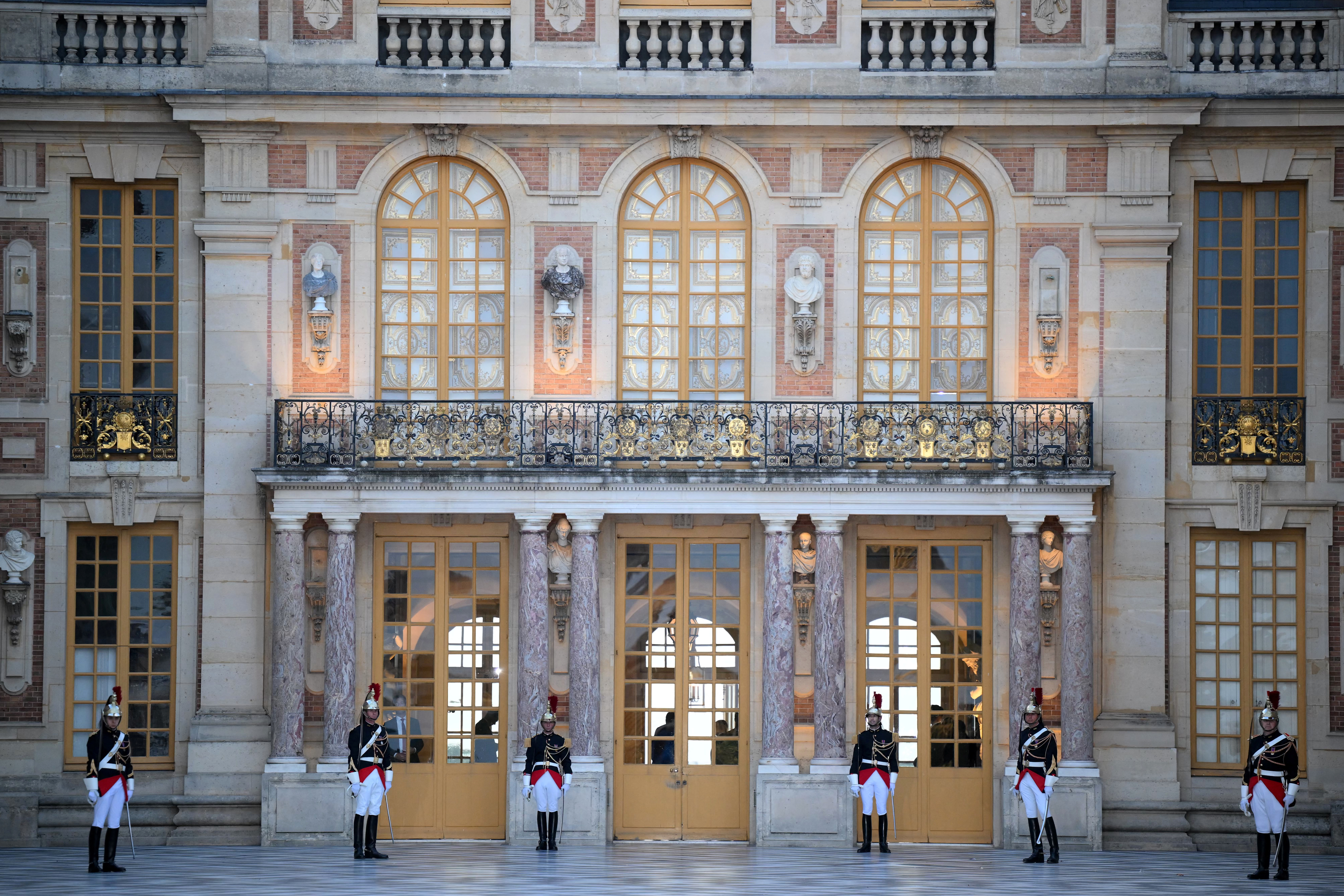 French Republican Guard stand to attention at the Palace of Versailles ahead of a state banquet, west of Paris, on September 20, 2023, on the first day of a British royal state visit to France. DANIEL LEAL