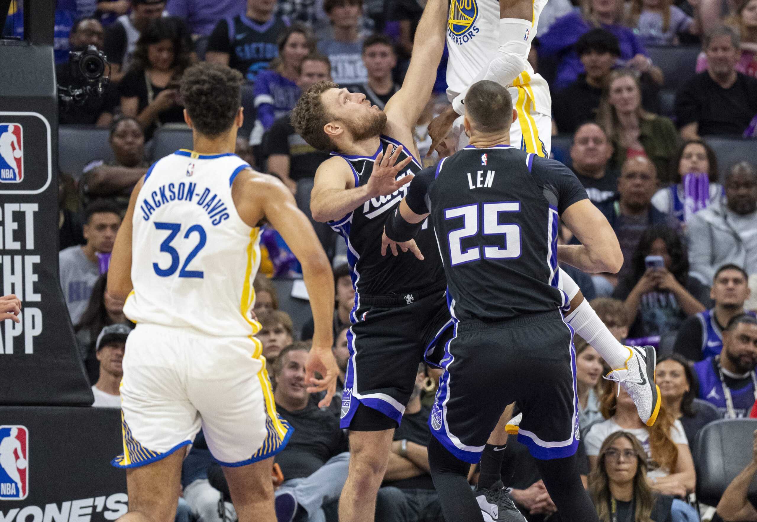 Oct 15, 2023; Sacramento, California, USA; Golden State Warriors forward Jonathan Kuminga (00) shoots a layup against Sacramento Kings forward Sasha Vezenkov (7) during the fourth quarter at Golden 1 Center. Mandatory Credit: Neville E. Guard-USA TODAY Sports