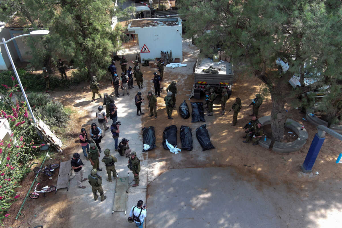 An aerial view shows the bodies of victims of an attack following a mass infiltration by Hamas gunmen from the Gaza Strip, lie on the ground in Kibbutz Kfar Aza, in southern Israel, October 10, 2023. REUTERS