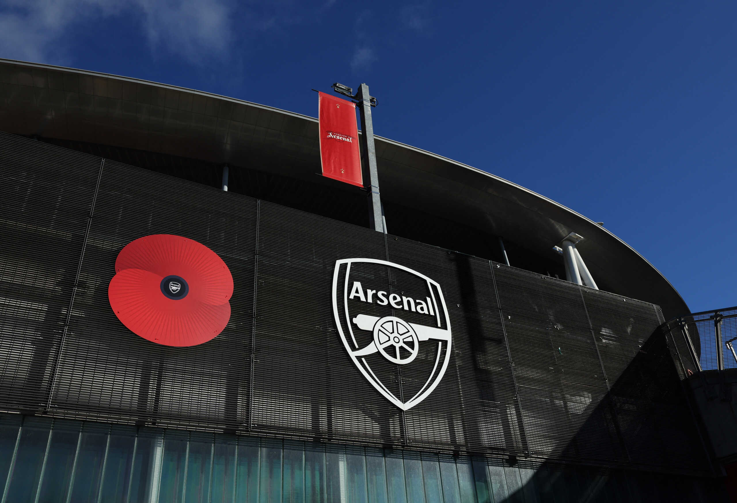 Soccer Football - Premier League - Arsenal v Burnley - Emirates Stadium, London, Britain - November 11, 2023  General view of a poppy and the Arsenal emblem outside the stadium before the match REUTERS