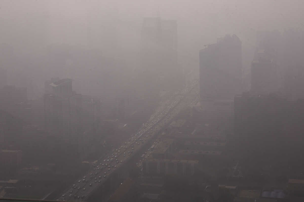 Vehicles move on a street in Beijing's Central Business District (CBD) as the city is shrouded in smog, in China November 1, 2023. REUTER