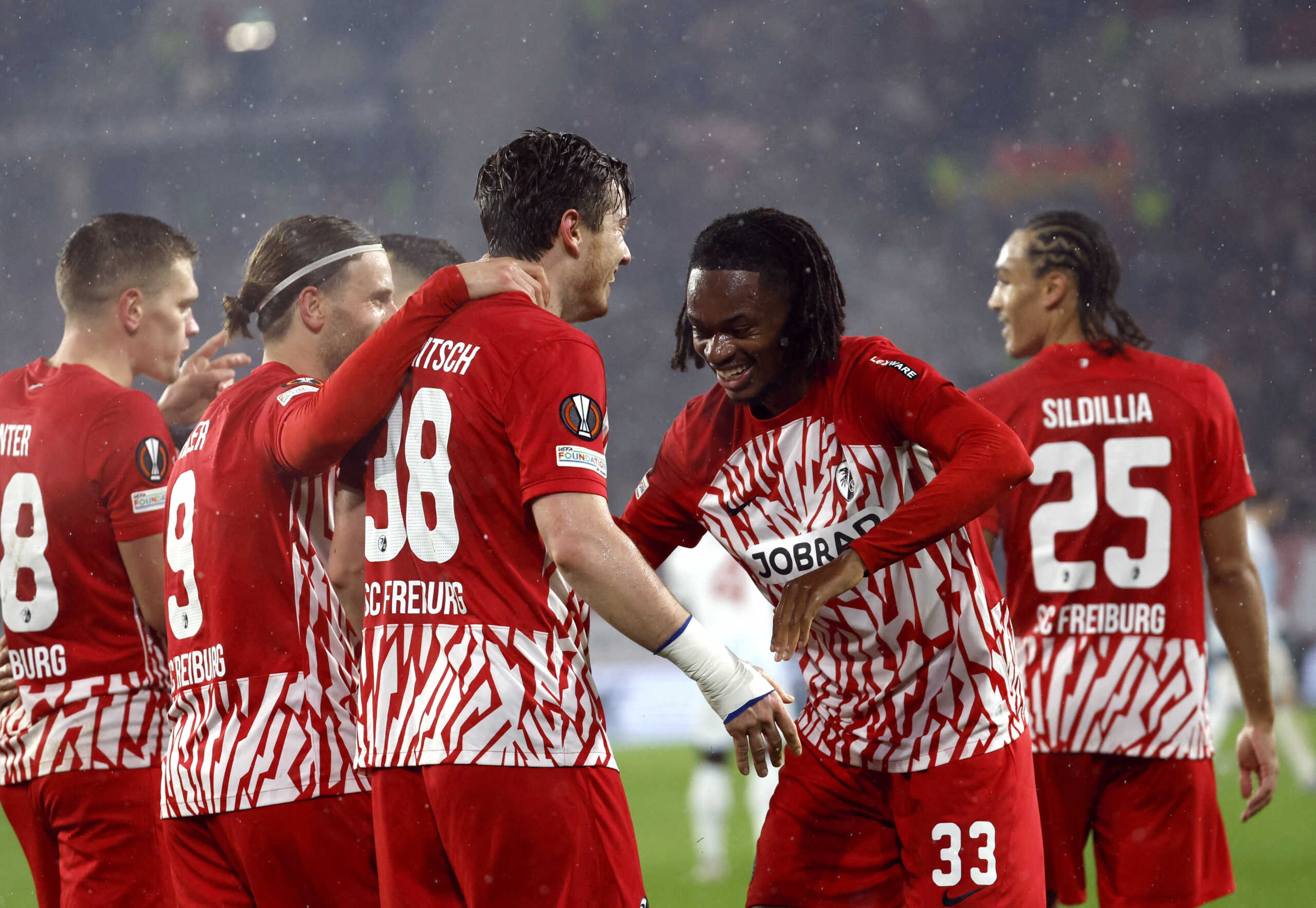Soccer Football - Europa League - Group A - SC Freiburg v Olympiacos - Europa Park Stadion, Freiburg, Germany - November 30, 2023 SC Freiburg's Michael Gregoritsch celebrates scoring their third goal with Jordy Makengo REUTERS