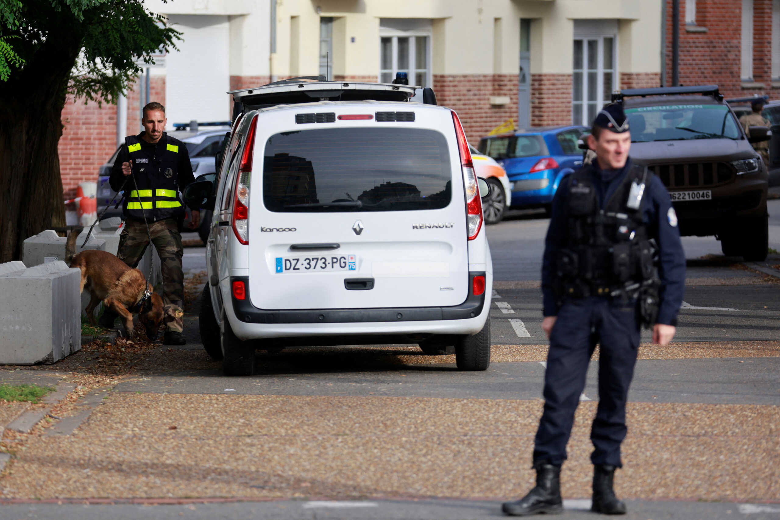 French police and police explosives expert team work on site after the evacuation of the Gambetta-Carnot school, where French teacher Dominique Bernard was killed in a knife attack on Friday, following a bomb alert in Arras, northern France, October 16, 2023. REUTERS