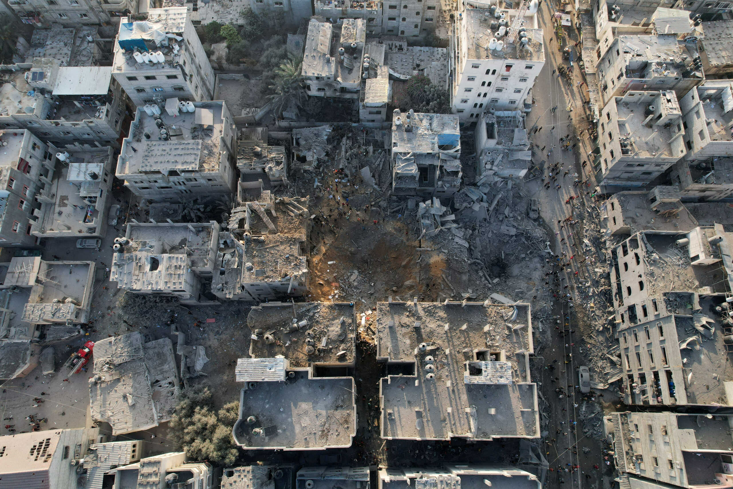 Palestinians gather at the site of Israeli strikes on houses in Maghazi, in the central Gaza Strip, November 3, 2023. REUTERS