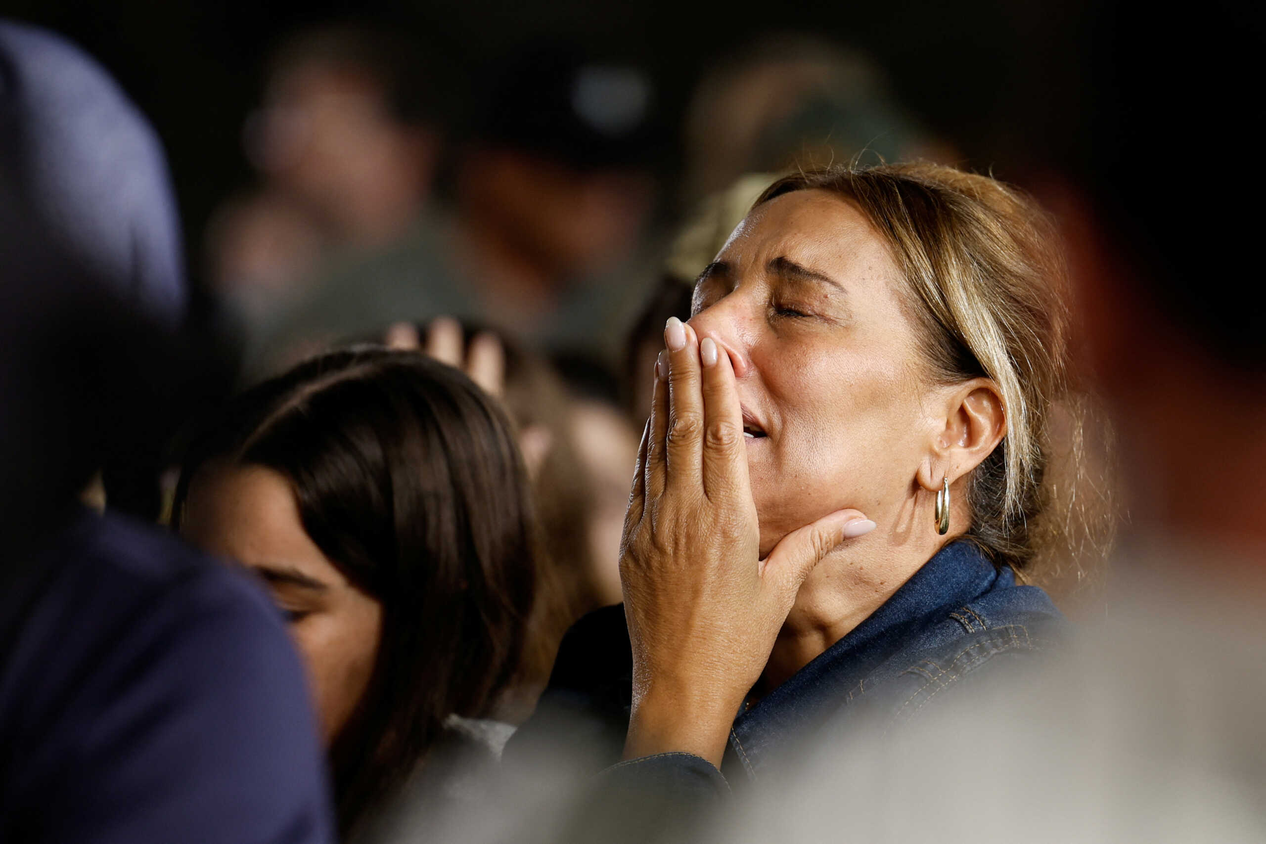 A woman reacts as people gather near the Western Wall in the Old City of Jerusalem, Judaism's holiest prayer site, for a special candle-lighting ceremony on the eve of the one-month anniversary of the deadly attack by the Palestinian Islamist group Hamas on October 7th, in Jerusalem, November 6, 2023. REUTERS