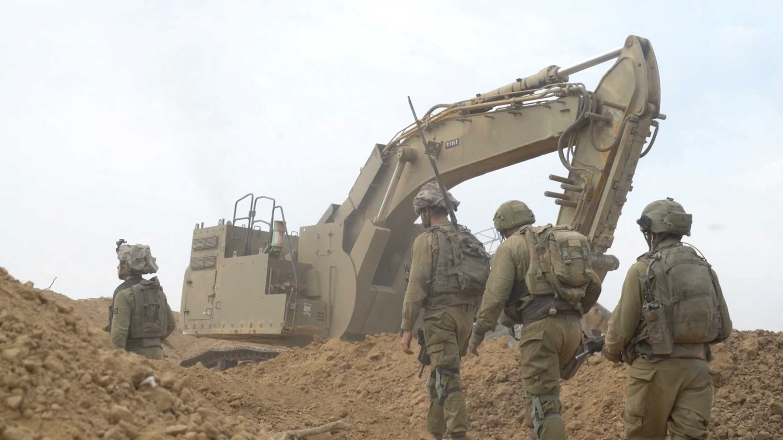 Israeli soldiers take position during the ongoing ground operation of the Israeli army against Palestinian Islamist group Hamas, in a location given as Gaza, in this screen grab from a handout video released on November 13, 2023. Israeli Defense Forces