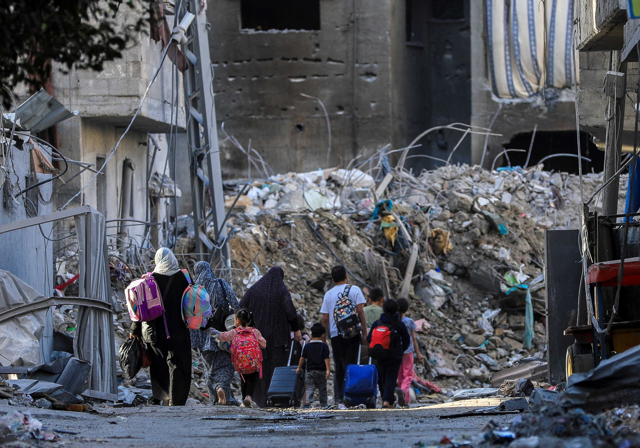 Palestinians carry their belongings as they flee their houses, amid the ongoing conflict between Israel and Palestinian Islamist group Hamas, in Gaza City November 7, 2023. REUTERS
