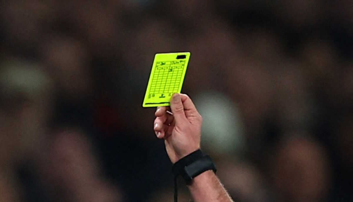 Soccer Football - Premier League - Tottenham Hotspur v Chelsea - Tottenham Hotspur Stadium, London, Britain - November 6, 2023 Tottenham Hotspur manager Ange Postecoglou is shown a yellow card by referee Michael Oliver Action Images via Reuters