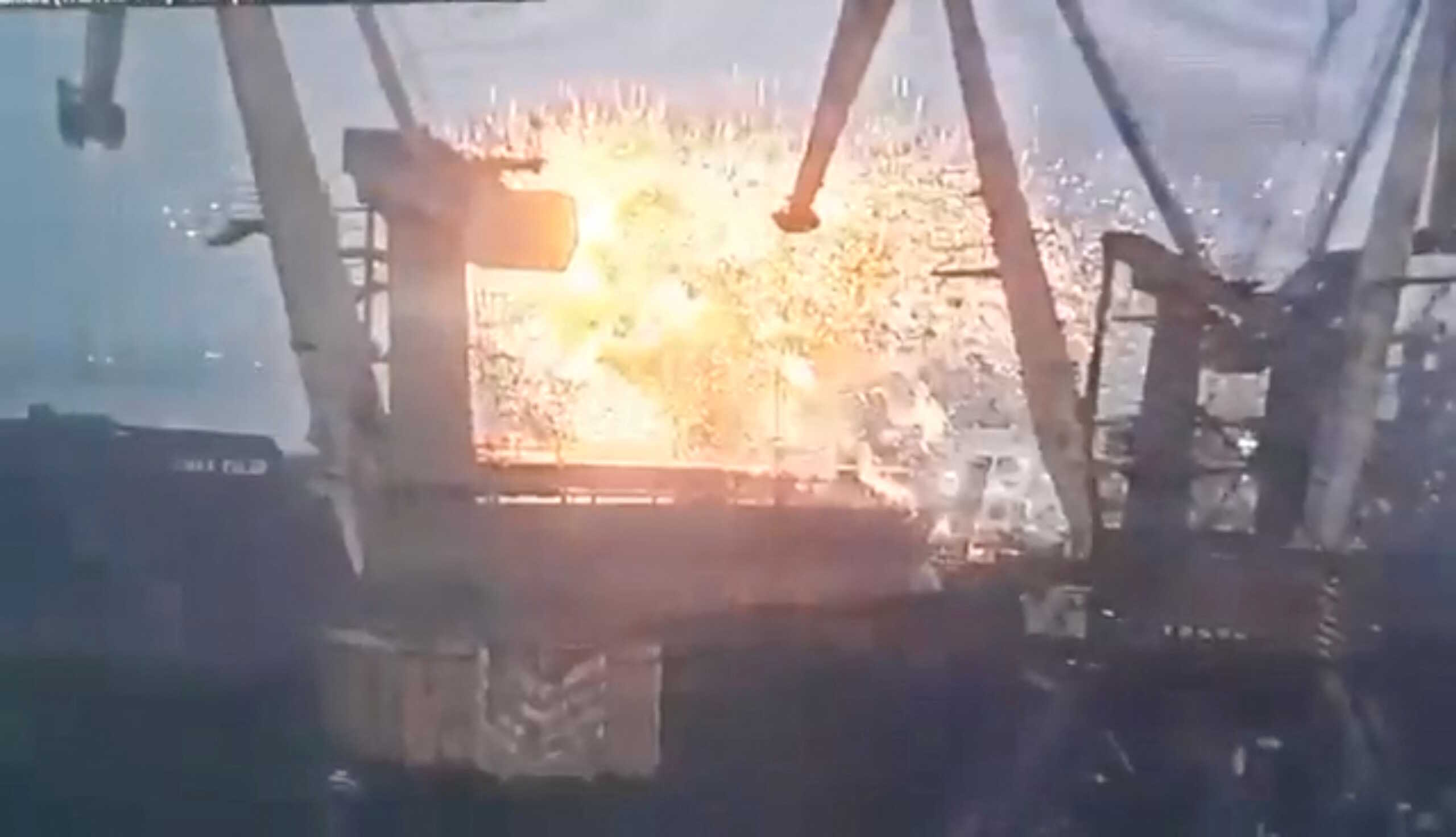 Screen grab from a phone recording of a screen with CCTV footage, obtained from social media, shows the moment of a missile strike on a Liberian-flagged civilian ship in a Ukrainian port, what Ukrainian officials said was a Russian missile strike, amid Russia's attack on Ukraine, in Odesa Region, Ukraine, November 8, 2023. Video obtained by Reuters
