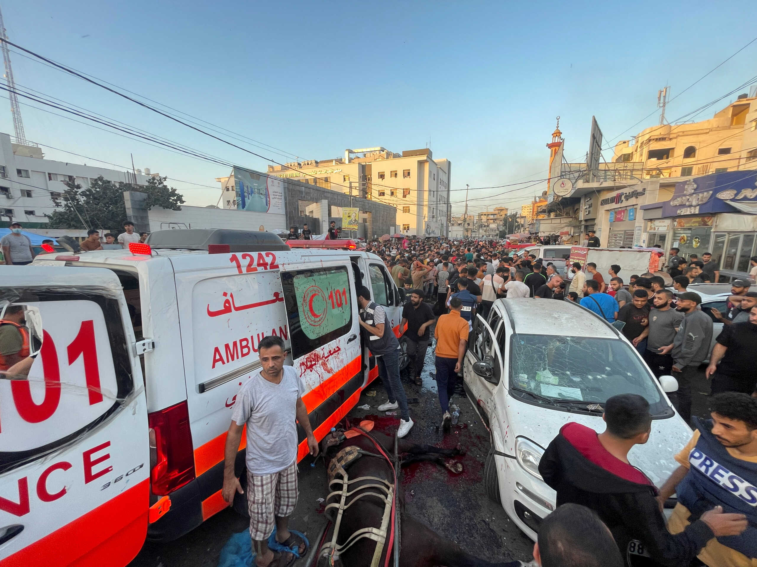 Palestinians check the damages after a convoy of ambulances was hit, at the entrance of Shifa hospital in Gaza City, November 3, 2023. REUTERS