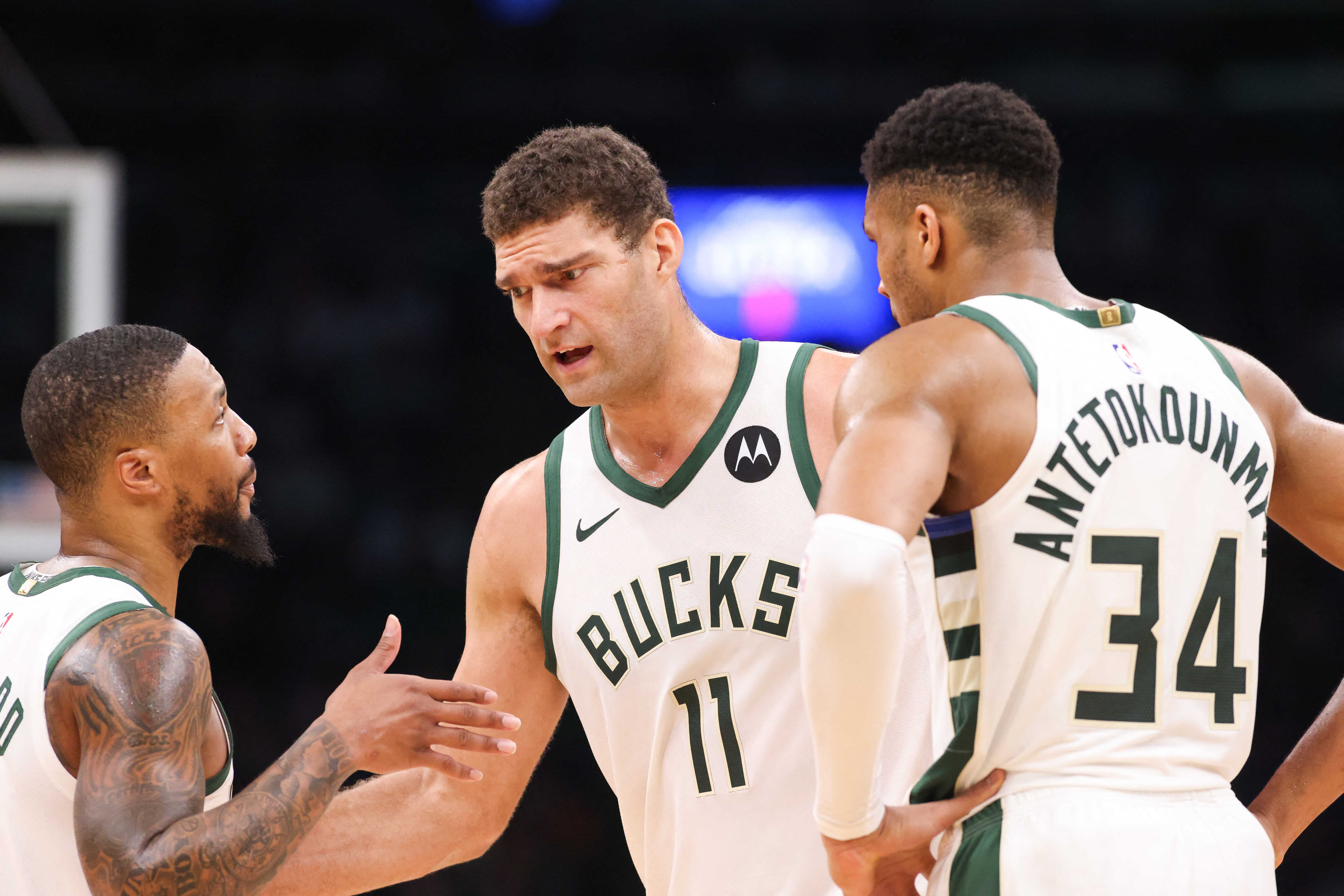 Nov 22, 2023; Boston, Massachusetts, USA; Milwaukee Bucks center Brook Lopez (11) talks to Milwaukee Bucks forward Giannis Antetokounmpo (34) and Milwaukee Bucks guard Damian Lillard (0) during the first half against the Boston Celtics at TD Garden. Mandatory Credit: Paul Rutherford-USA TODAY Sports