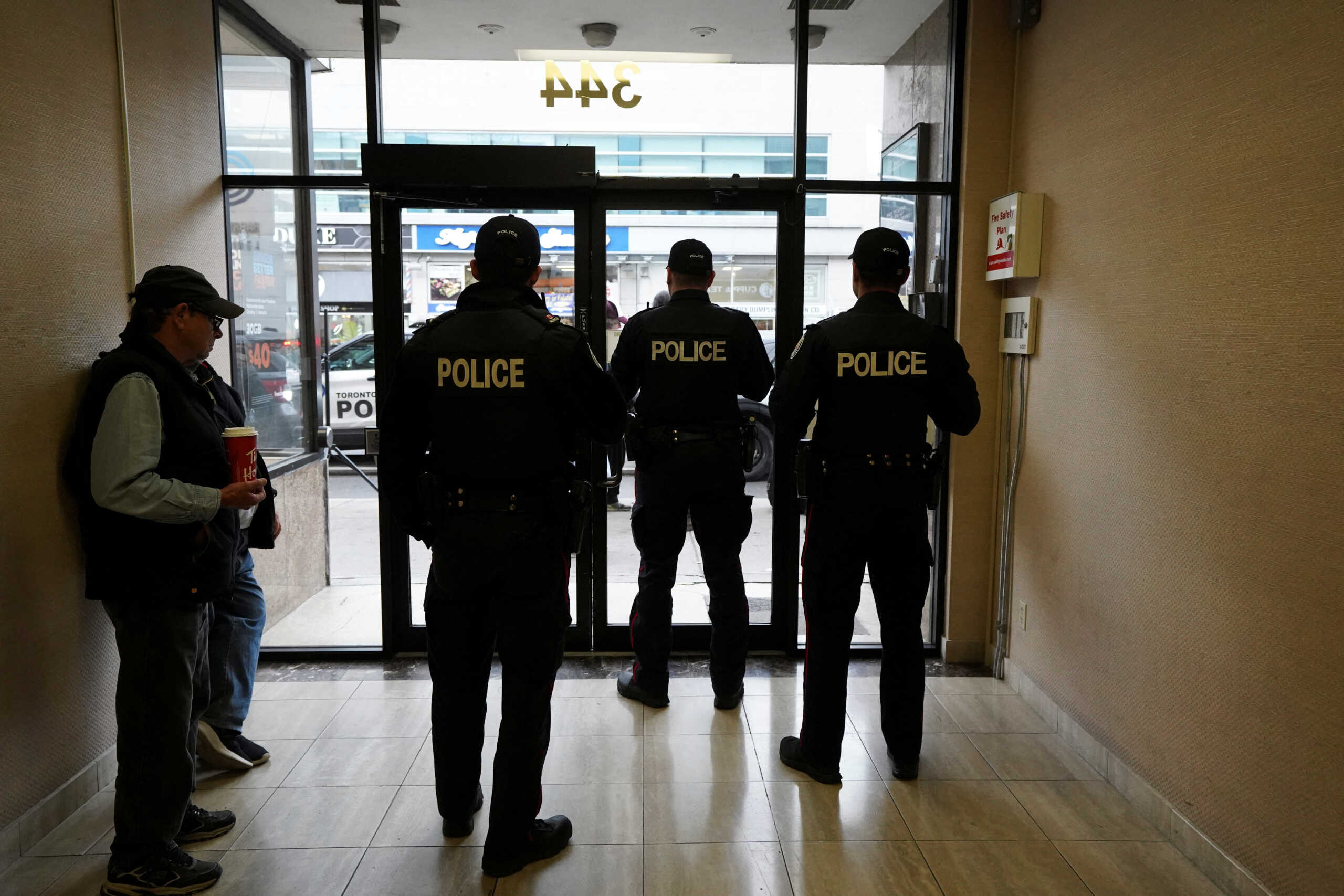 Toronto Police officers guard the entrance to the constituent office of Canada's Deputy Prime Minister and Finance Minister Chrystia Freeland during a protest in Toronto, Ontario, Canada October 30, 2023.  REUTERS