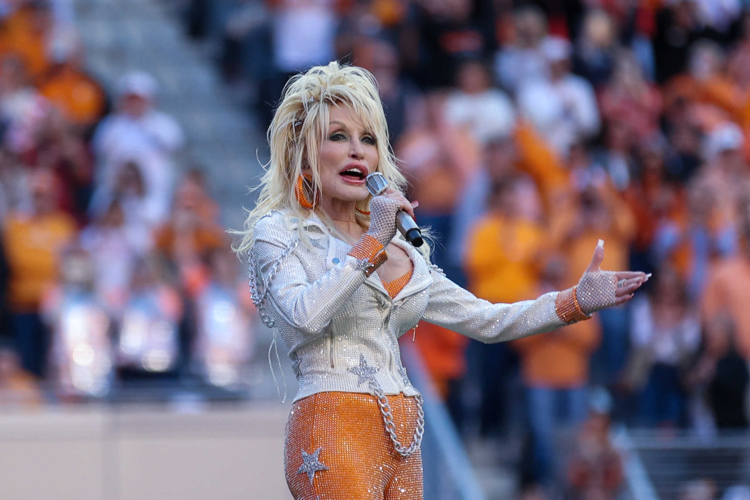 Nov 18, 2023; Knoxville, Tennessee, USA; Country music artist Dolly Parton sings to the crowd during a break in a game between the Tennessee Volunteers and the Georgia Bulldogs at Neyland Stadium. Mandatory Credit: Randy Sartin-USA TODAY Sports