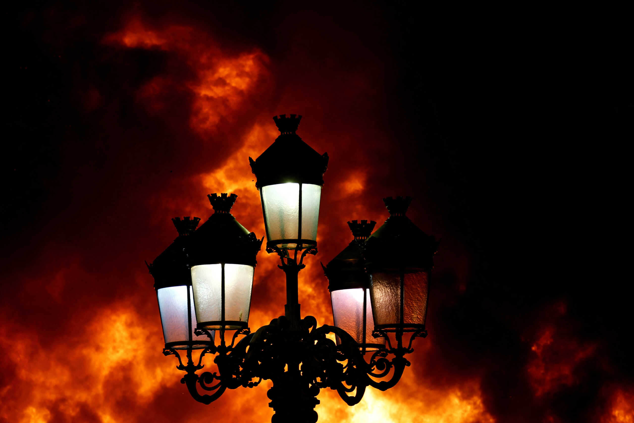 Dublin's Five Lamps street lights are seen engulfed in flames as a riot breaks out following a school stabbing that left several children and adults, in Dublin, Ireland, November 23, 2023. REUTERS