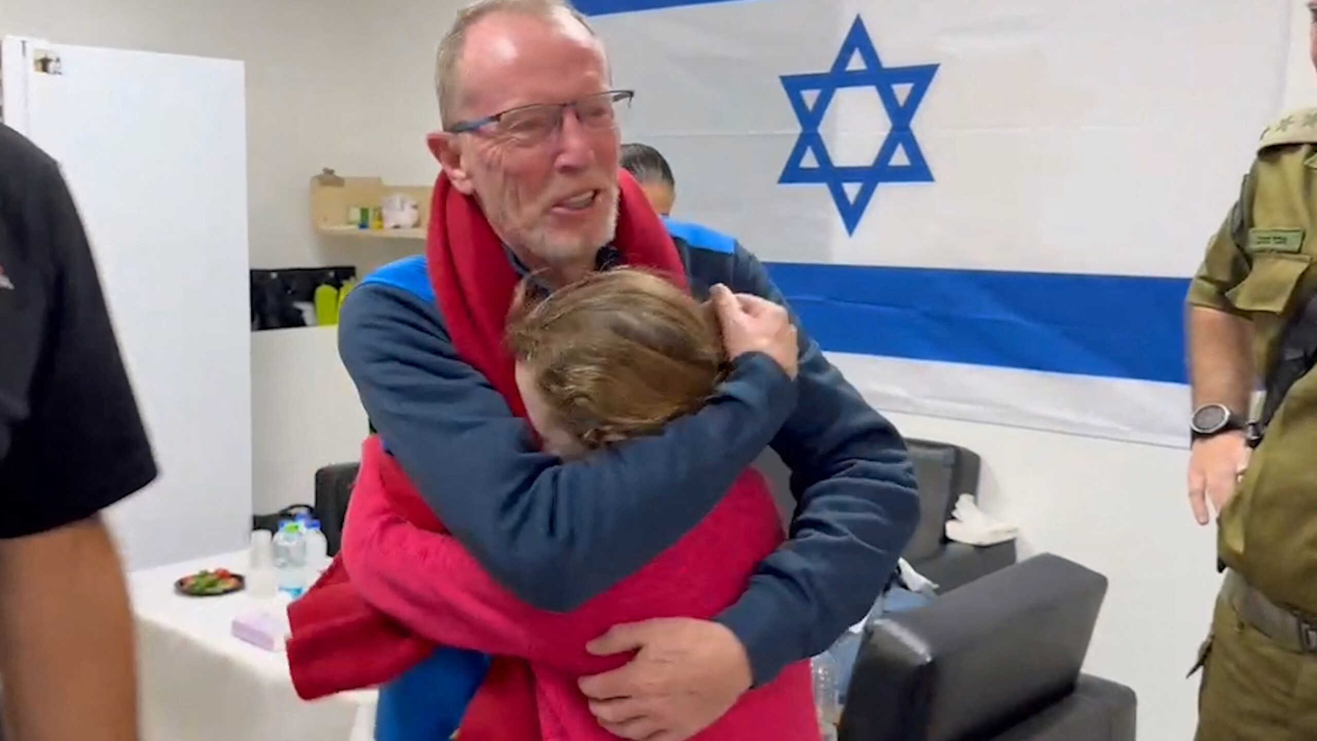 Irish-Israeli girl Emily Hand, who was abducted by Hamas gunmen during the October 7 attack on Israel, meets her father Thomas Hand after being released as part of a hostages-prisoners swap deal between Hamas and Israel amid a temporary truce, at an unknown location in Israel, in this screengrab from a handout video released November 26, 2023.   Israel Defense Forces
