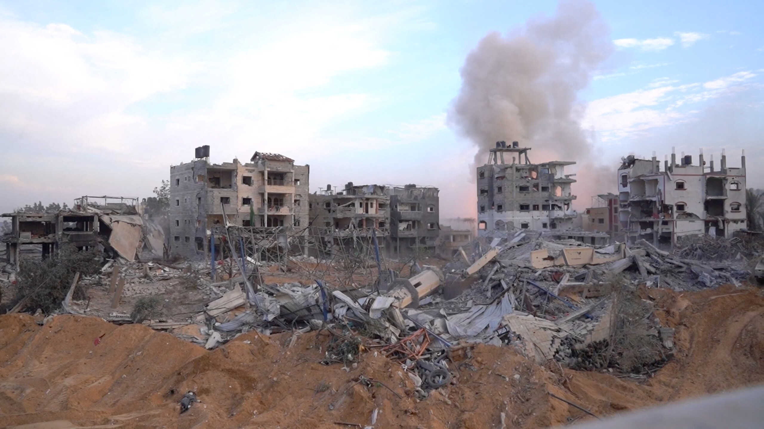 A smoke raises over the buildings as Israeli soldiers operate inside the Gaza Strip, amid the ongoing ground operation of the Israeli army against Palestinian Islamist group Hamas, in this handout picture obtained by Reuters on November 7, 2023. Israeli Defense Forces