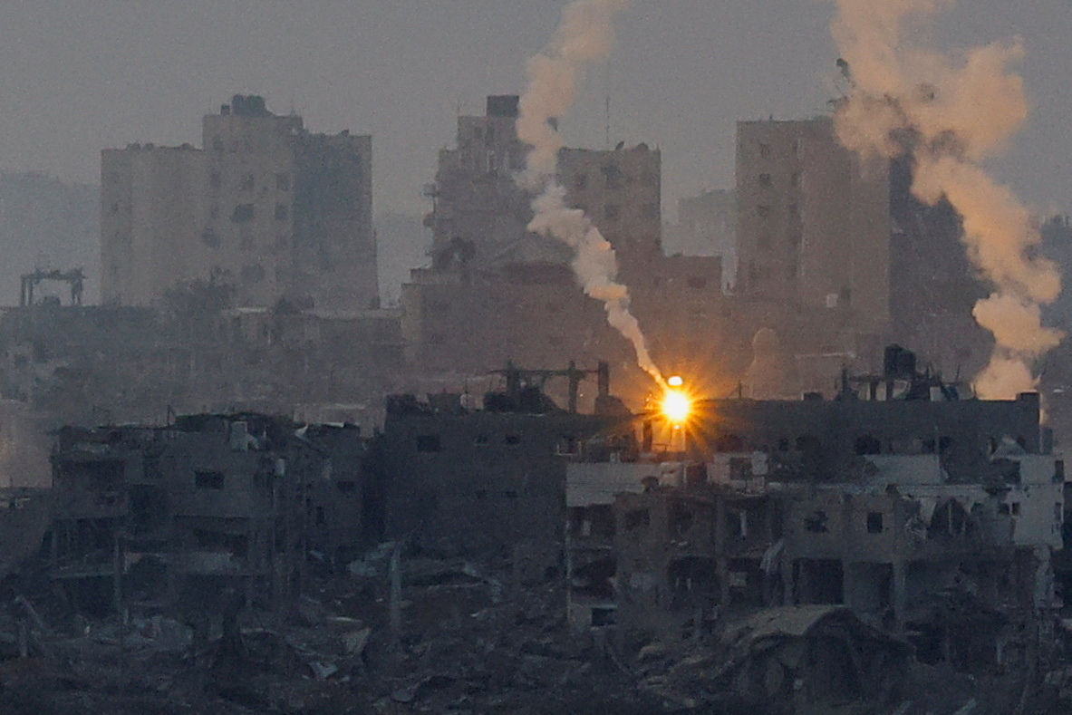 A flare burns above Gaza, as seen from southern Israel, amid the ongoing conflict between Israel and the Palestinian group Hamas, November 14, 2023. REUTERS