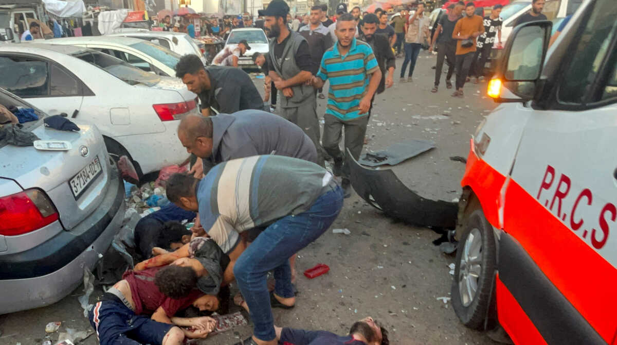 SENSITIVE MATERIAL. THIS IMAGE MAY OFFEND OR DISTURB    Palestinians remove bodies of people who were killed after a convoy of ambulances was hit, at Shifa hospital entrance in Gaza City, November 3, 2023. REUTERS