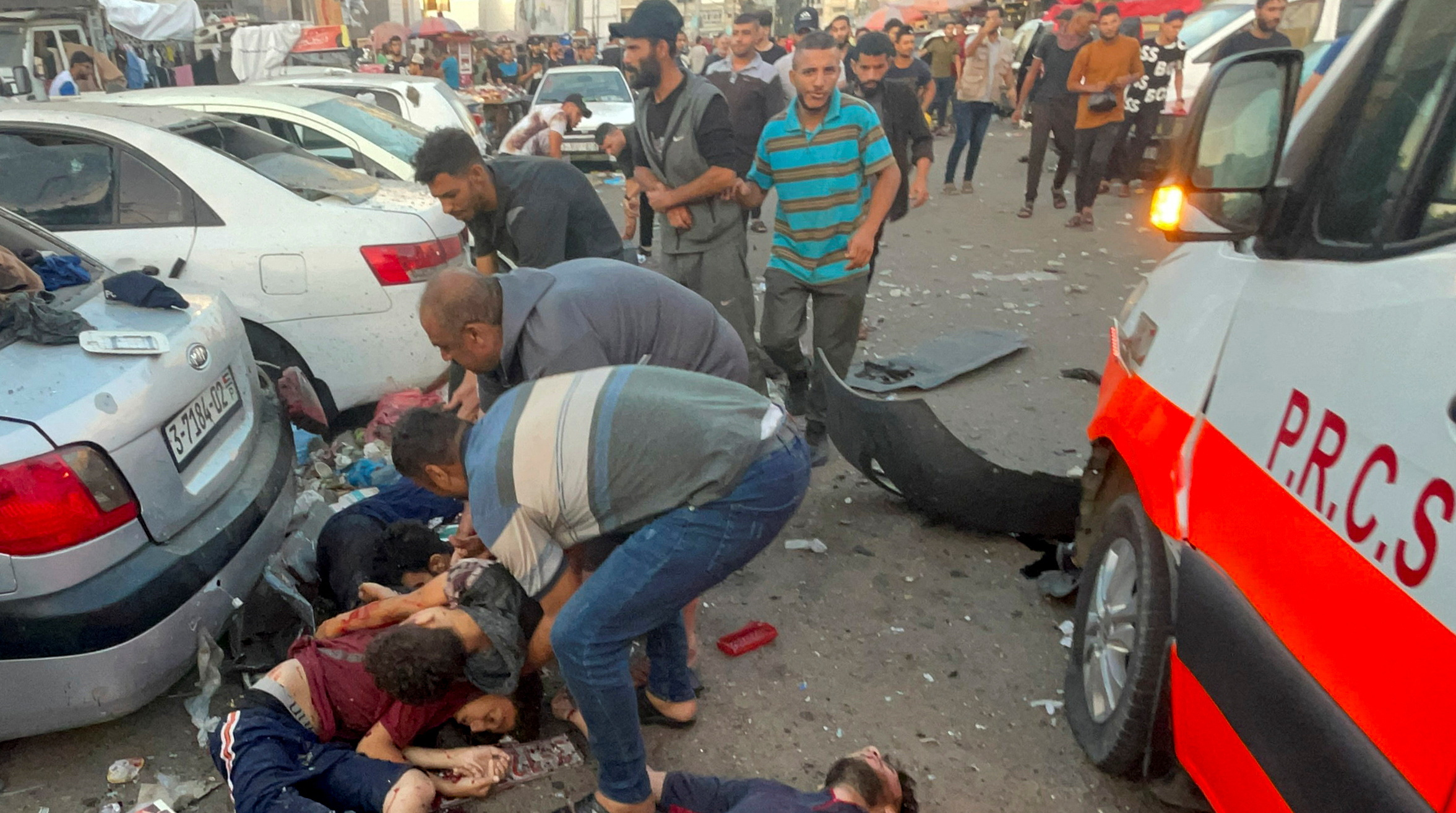 SENSITIVE MATERIAL. THIS IMAGE MAY OFFEND OR DISTURB    Palestinians remove bodies of people who were killed after a convoy of ambulances was hit, at Shifa hospital entrance in Gaza City, November 3, 2023. REUTERS