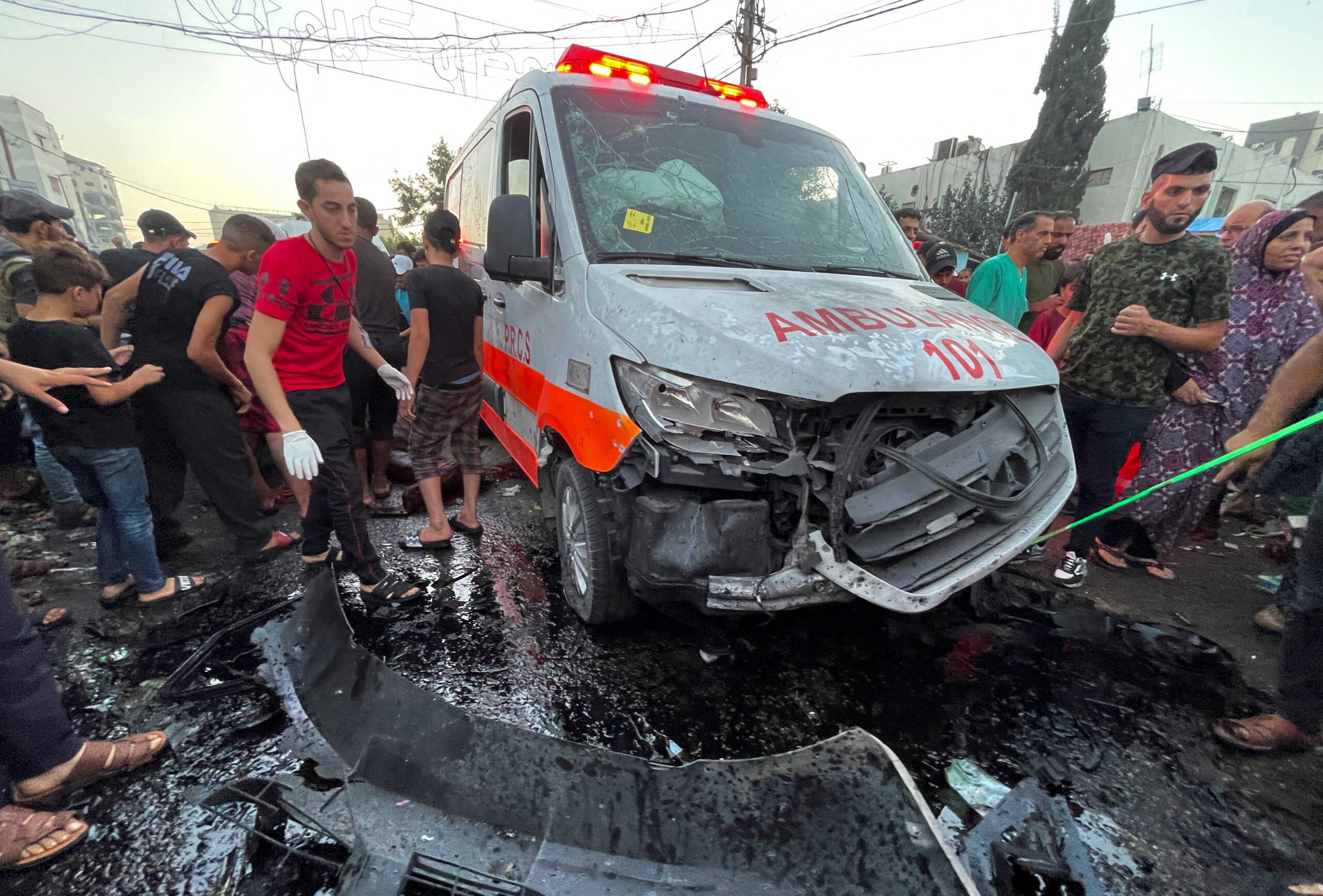 Palestinians check the damages after a convoy of ambulances was hit, at the entrance of Shifa hospital in Gaza City, November 3, 2023. REUTERS