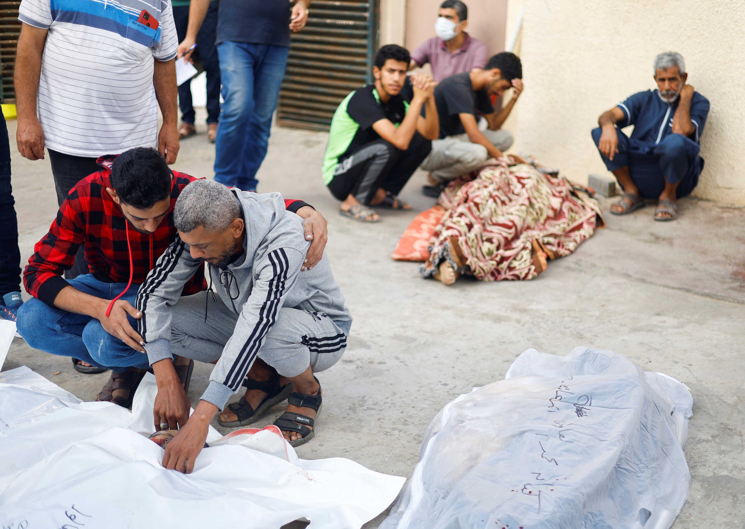 SENSITIVE MATERIAL. THIS IMAGE MAY OFFEND OR DISTURB    Palestinians react next to the bodies of people killed in Israeli strikes, amid the ongoing conflict between Israel and Palestinian Islamist group Hamas, at a hospital, in the central Gaza Strip, November 5, 2023. REUTERS