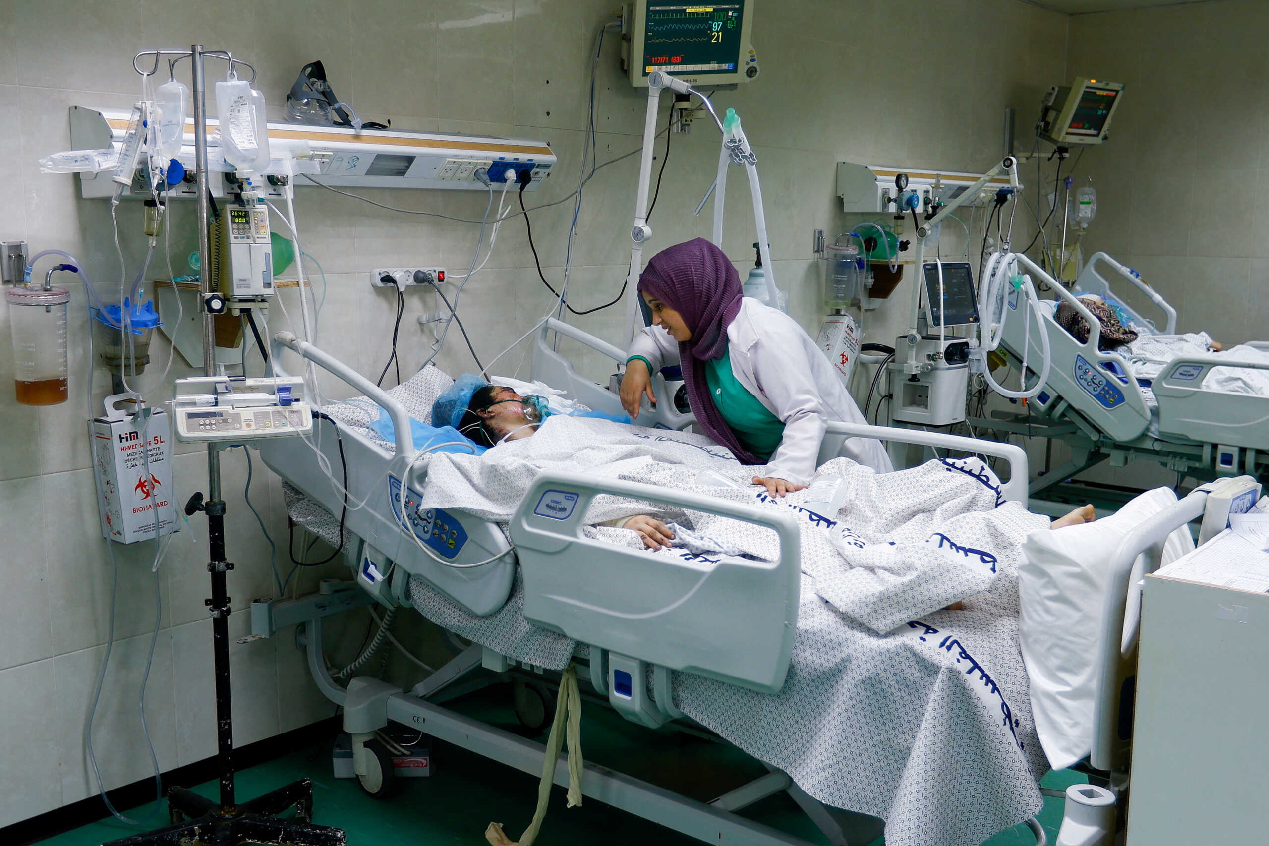 A medical worker assists a Palestinian, who was wounded in Israeli strikes, at the Intensive Care Unit (ICU) of Nasser hospital, as doctors say they are only able to accept critical cases that are in need of surgery, while the unit is filled up with victims of the ongoing conflict with Israel, in Khan Younis, in the southern Gaza Strip, October 26, 2023. REUTERS