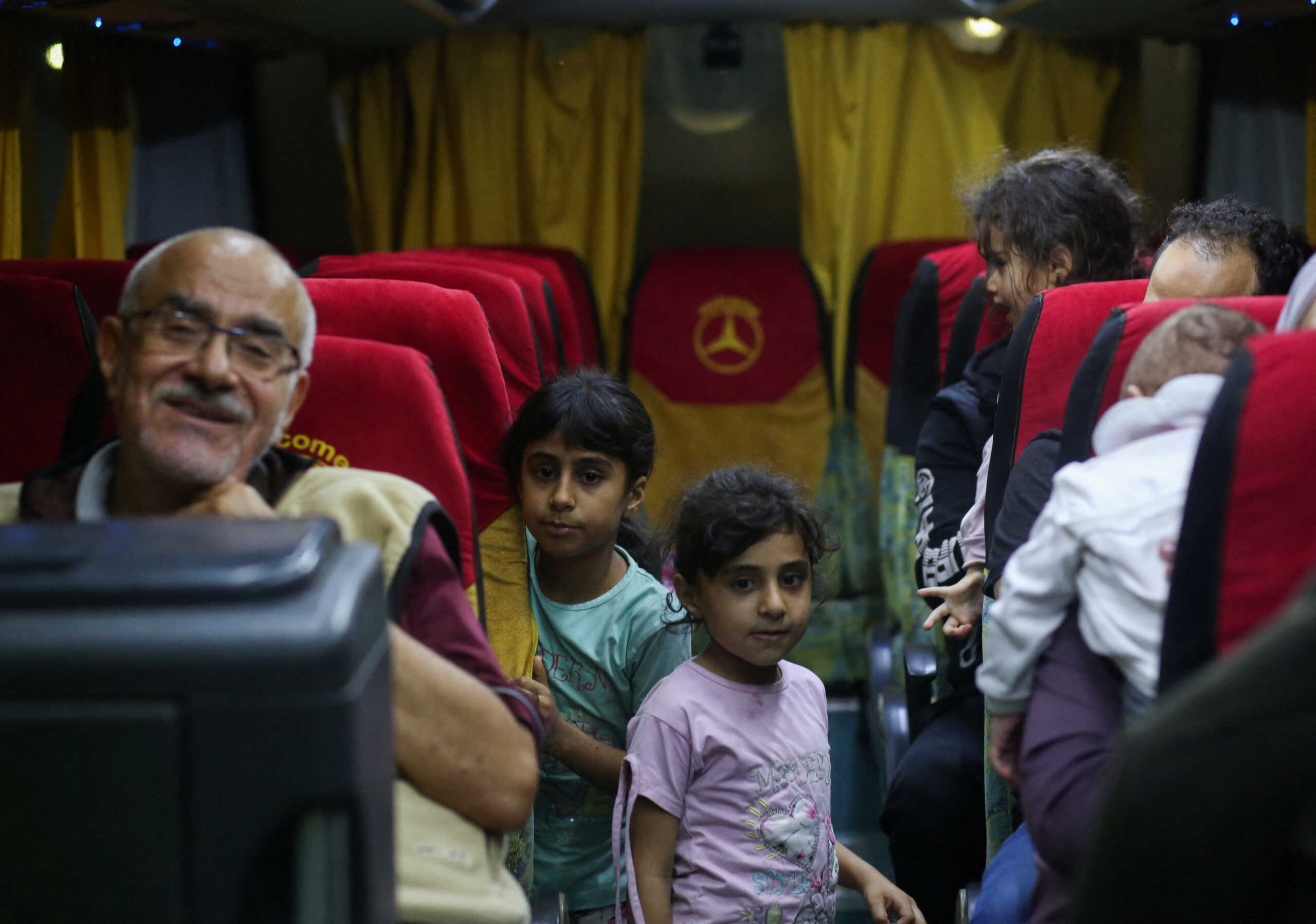Palestinians with Canadian passports who were evacuated from Gaza react on a bus after crossing through the Rafah border crossing from the Egyptian side, amid the ongoing conflict between Israel and Palestinian Islamist group Hamas, in Rafah, Egypt, November 12, 2023. REUTERS