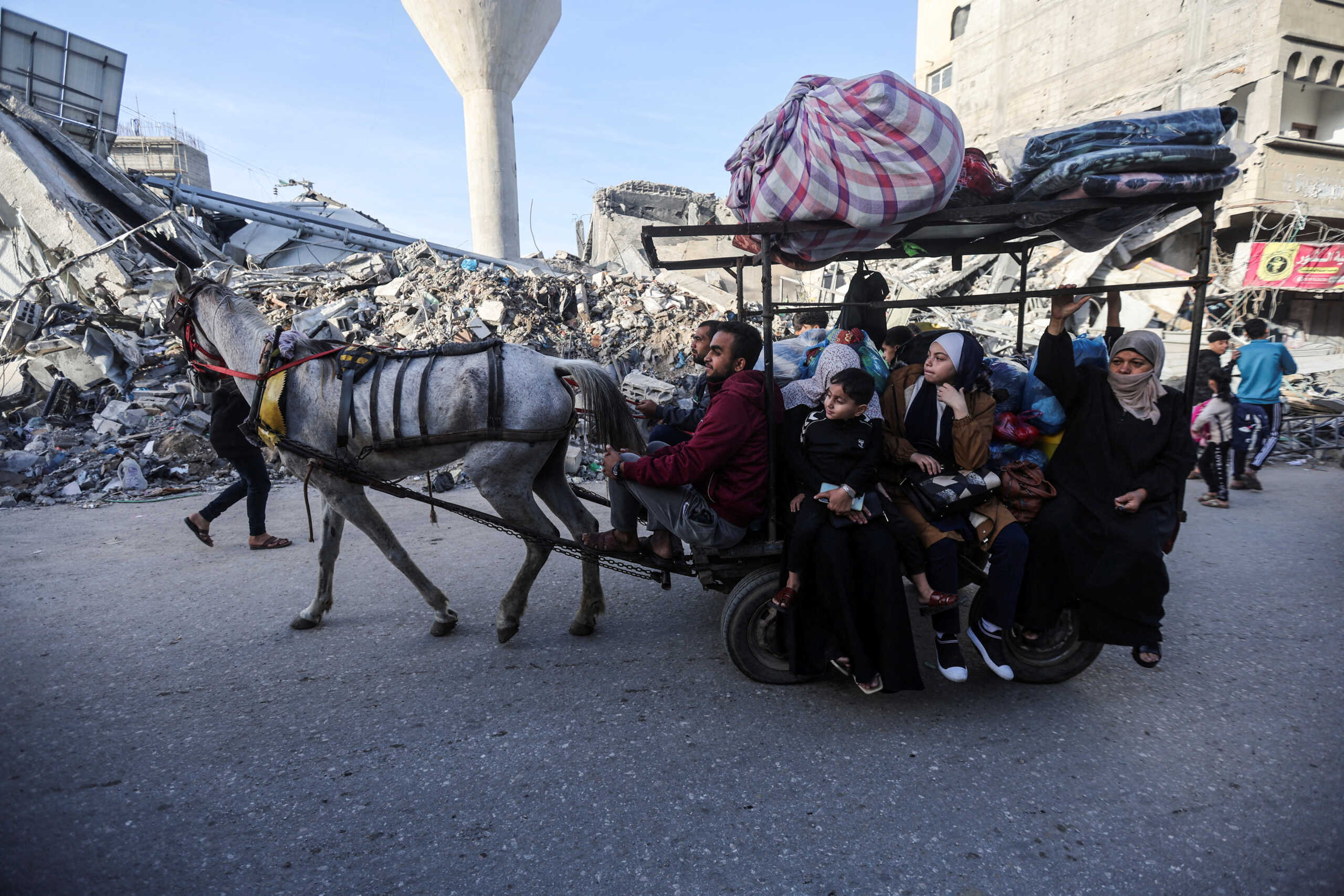 Displaced Palestinians ride on a donkey cart as they make their way home, during a temporary truce between Hamas and Israel, in Khan Younis in the southern Gaza Strip, November 24, 2023. REUTERS