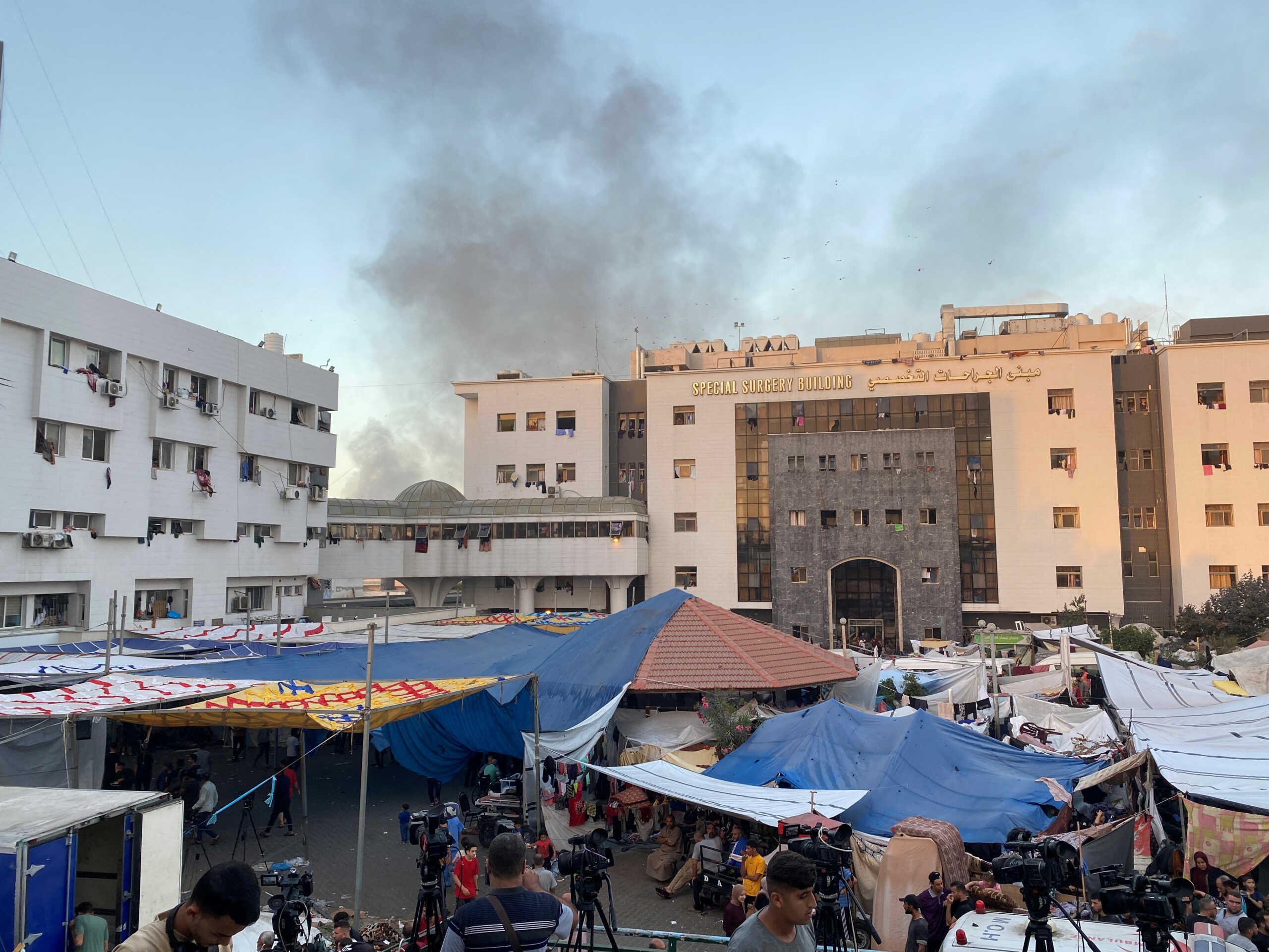 Smoke rises as displaced Palestinians take shelter at Al Shifa hospital, amid the ongoing conflict between Hamas and Israel, in Gaza City, November 8, 2023. REUTERS