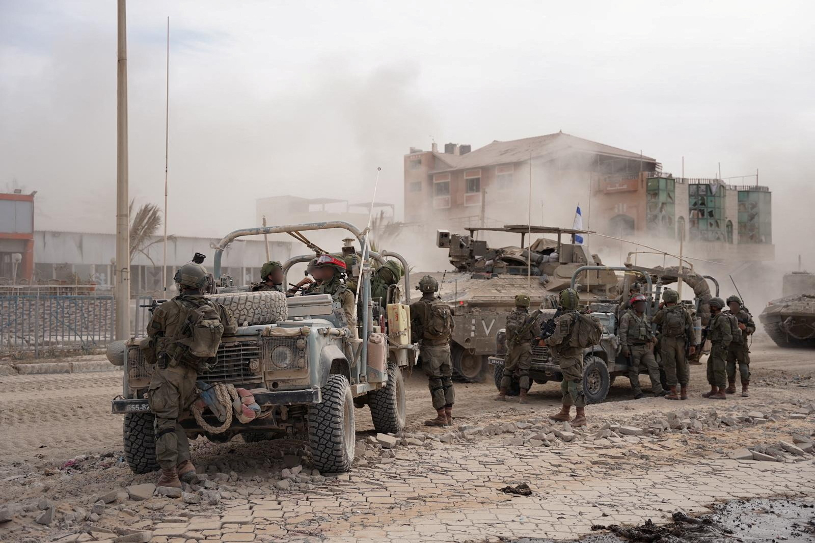 Israeli soldiers take position during the ongoing ground operation of the Israeli army against Palestinian Islamist group Hamas, in a location given as Gaza, in this handout picture released on November 13, 2023. Israeli Defense Forces