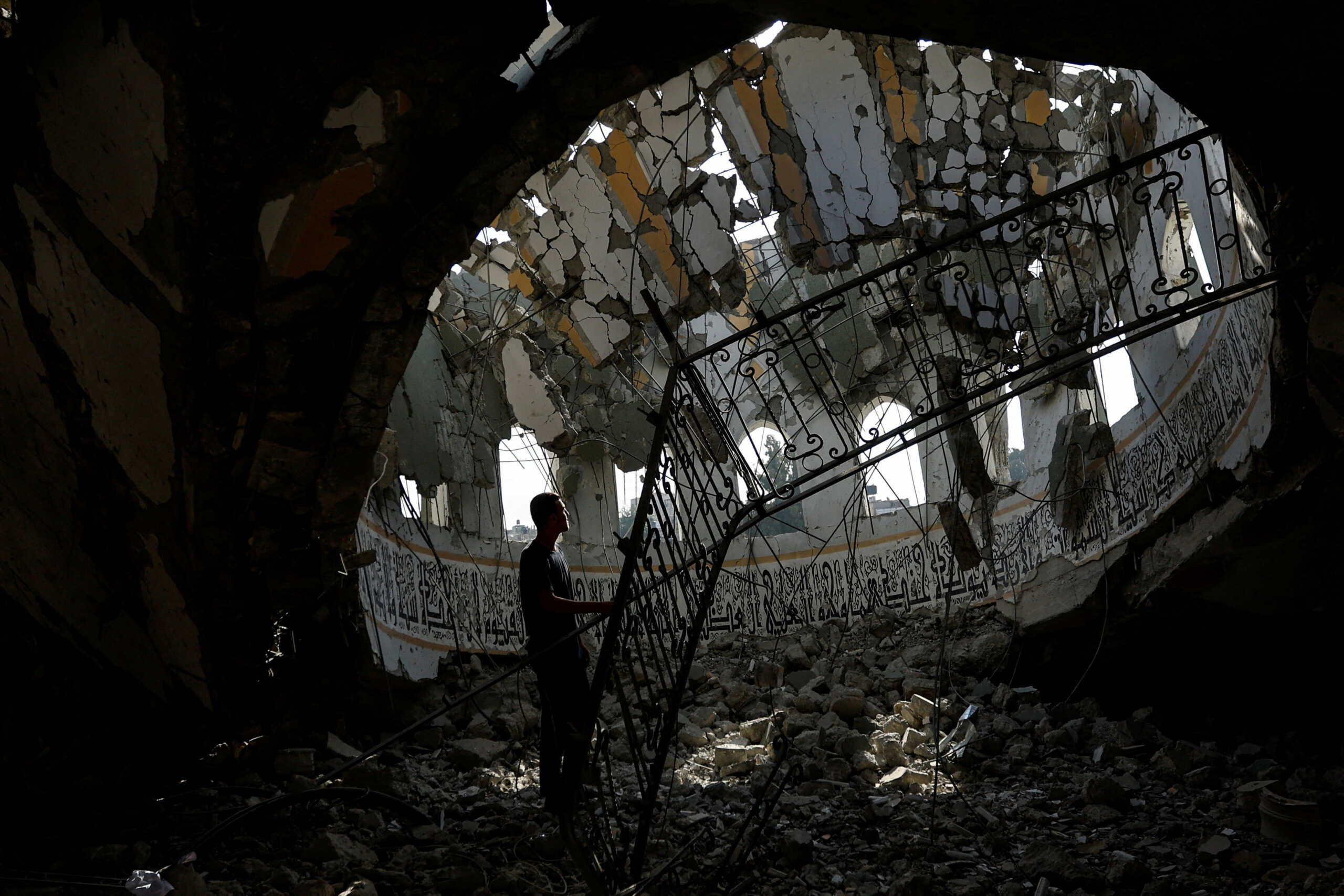 A Palestinian man inspects the site of an Israeli strike on a mosque, amid the ongoing conflict between Israel and Palestinian Islamist group Hamas, in Khan Younis in the southern Gaza Strip, November 9, 2023. REUTERS