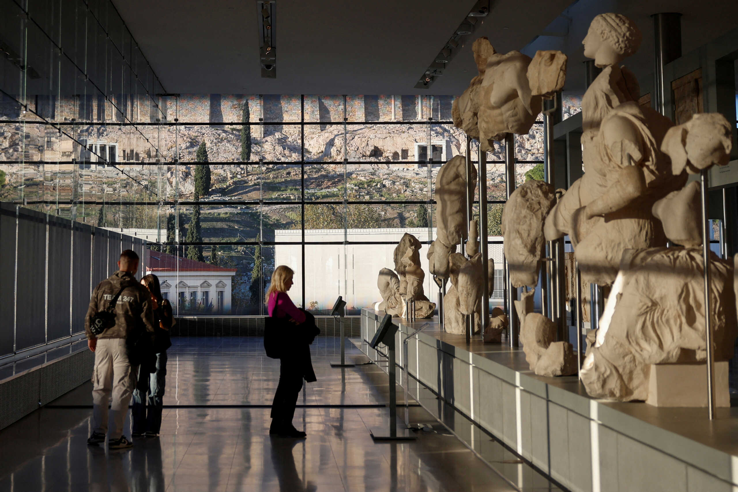 FILE PHOTO: FILE PHOTO: People visit the Parthenon Gallery, designed to accommodate the sculptures of the Parthenon, at the Acropolis Museum in Athens, Greece, November 27, 2023. REUTERS