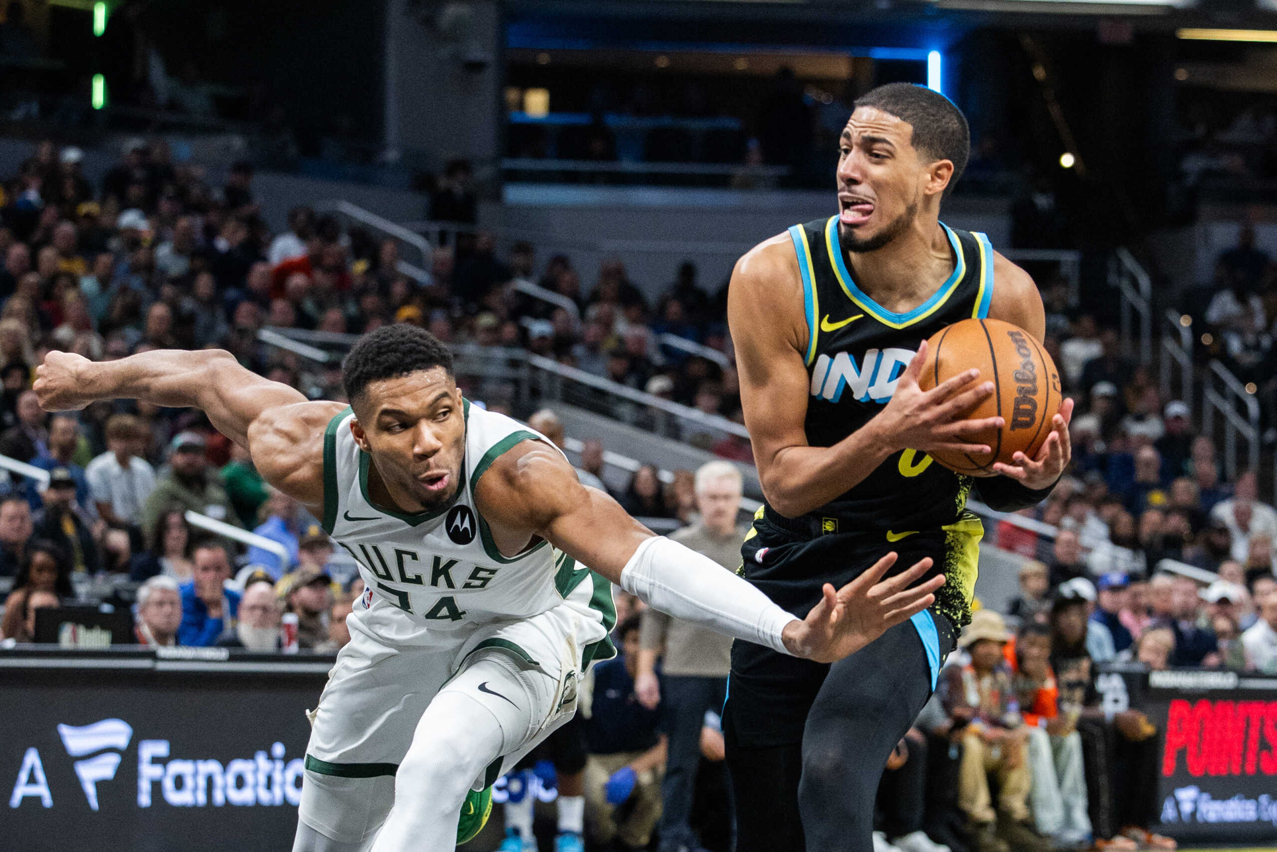 Nov 9, 2023; Indianapolis, Indiana, USA; Indiana Pacers guard Tyrese Haliburton (0) dribbles the ball while Milwaukee Bucks forward Giannis Antetokounmpo (34) defends in the second half at Gainbridge Fieldhouse. Mandatory Credit: Trevor Ruszkowski-USA TODAY Sports