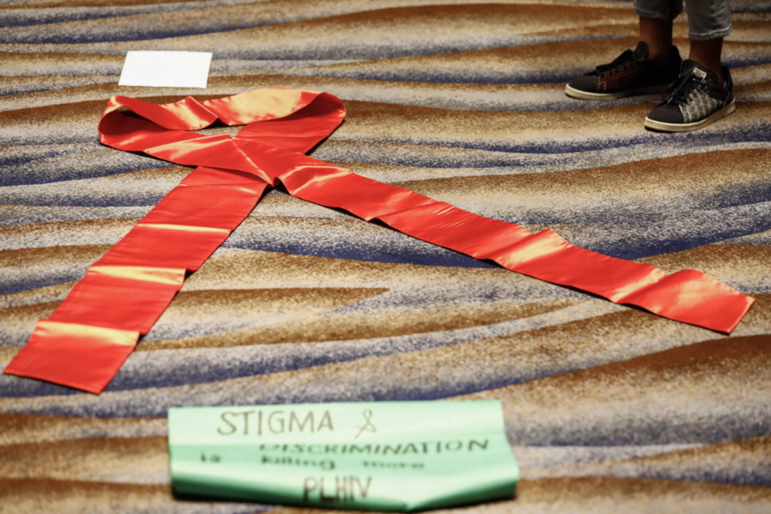 epa10645360 A red ribbon symbolizing global AIDS awareness is displayed during a forum of health rights advocates with journalists to mark International AIDS Candlelight Memorial in Quezon City, Metro Manila, Philippines, 22 May 2023. Data shared by the Action for Health Initiatives (ACHIEVE) and UNAIDS show that 6,474 people have died from AIDS-related deaths since 1984 in the Philippines, with 70 percent coming from youth below 35 years-old, and 45 percent of the deaths happening only in the last five years. Participants in the memorial called on the government for improved healthcare measures addressing HIV and AIDS cases in the country.  EPA